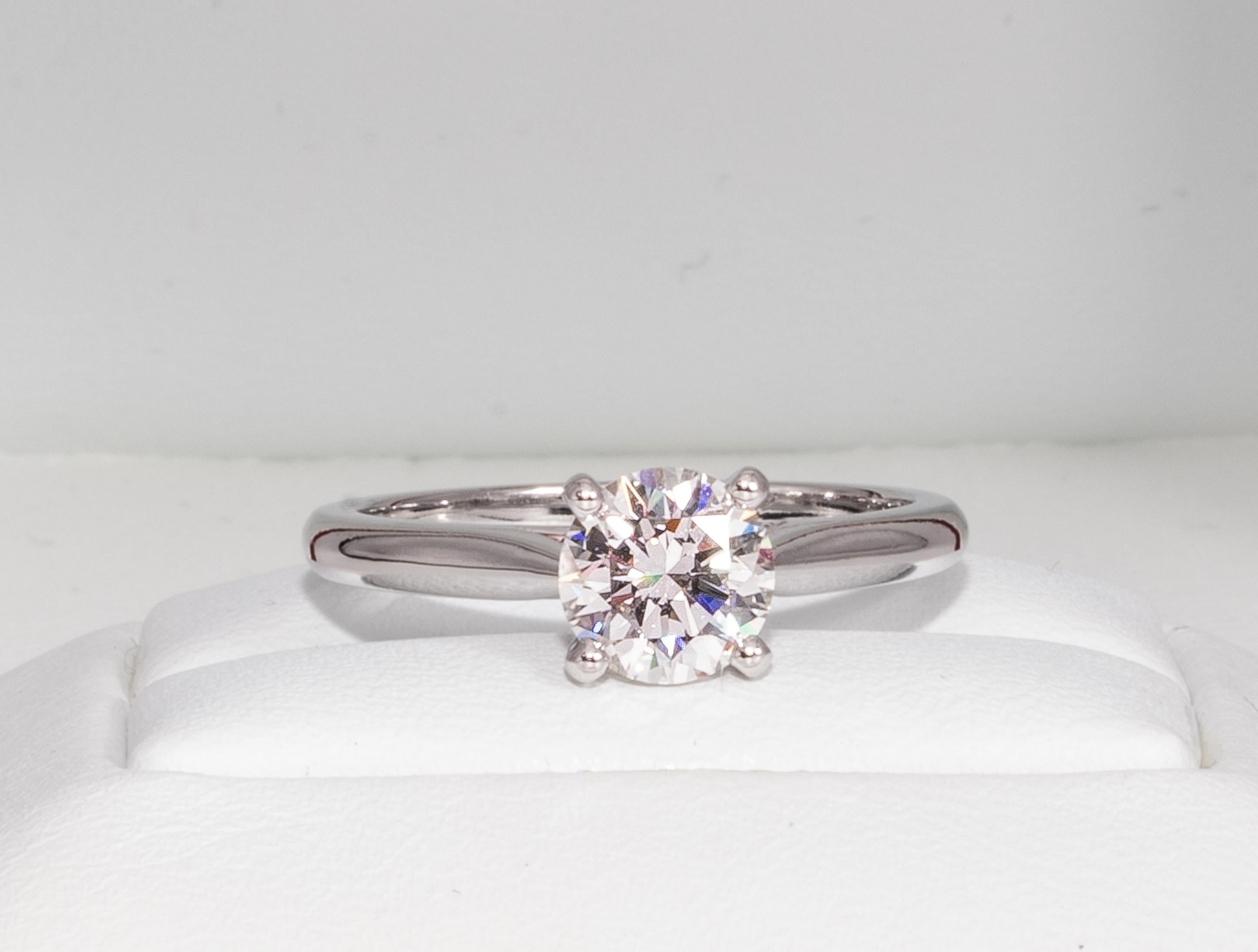 Cartier 1895 Platinum Diamond Engagement Ring signed by Cartier featuring a .91 ct Center, graded H color , and VVS2 Clarity.

Center: .91 H VVS2 GIA
Accompanied by GIA Grading Report #1142467339

Ring is currently a size 5.5 and can be expertly and