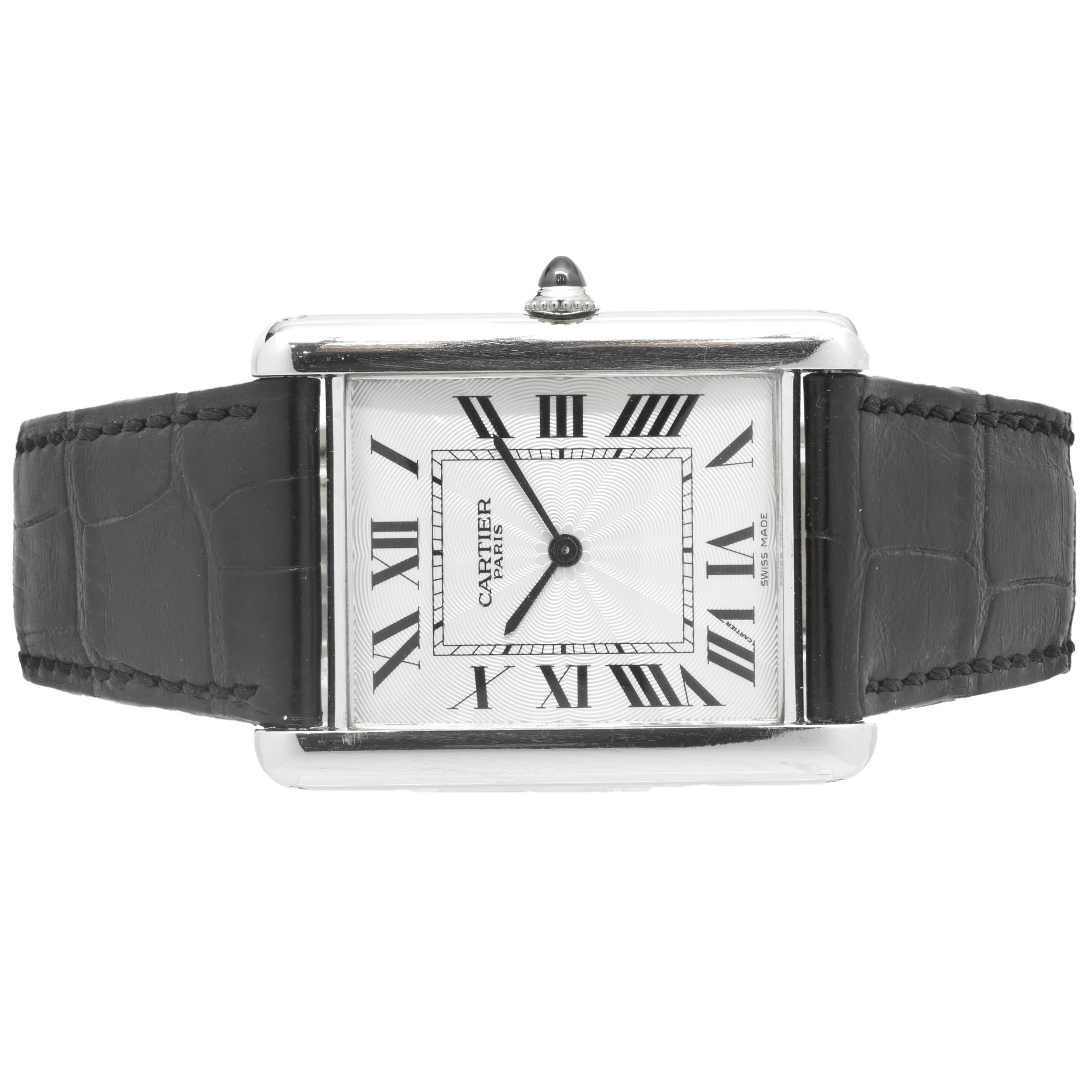 Movement: automatic
Function: hours, minutes
Case: 30 x 39mm rectangular case, push pull crown, sapphire crystal, smooth bezel
Dial: silver dial, steel sword sweeping hands
Band: Cartier black leather strap
Serial #: XX
Reference #: 2915

No box or