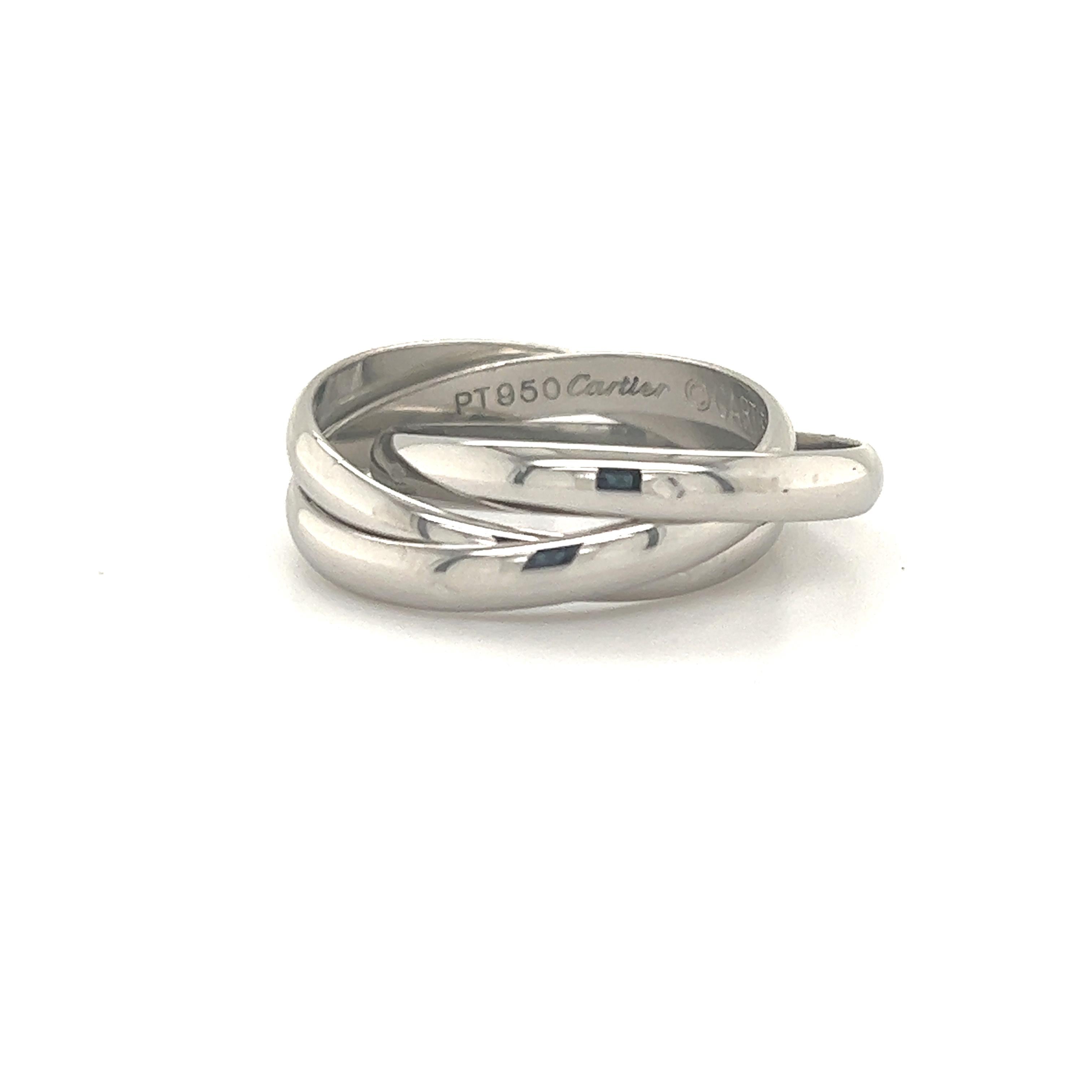    Timeless Cartier ring crafted in platinum. The ring is known as the trinity design as three single bands are interlocked creating a stacked unforgettable look when worn.  This ring in platinum is extremely rare as most designs of this ring are