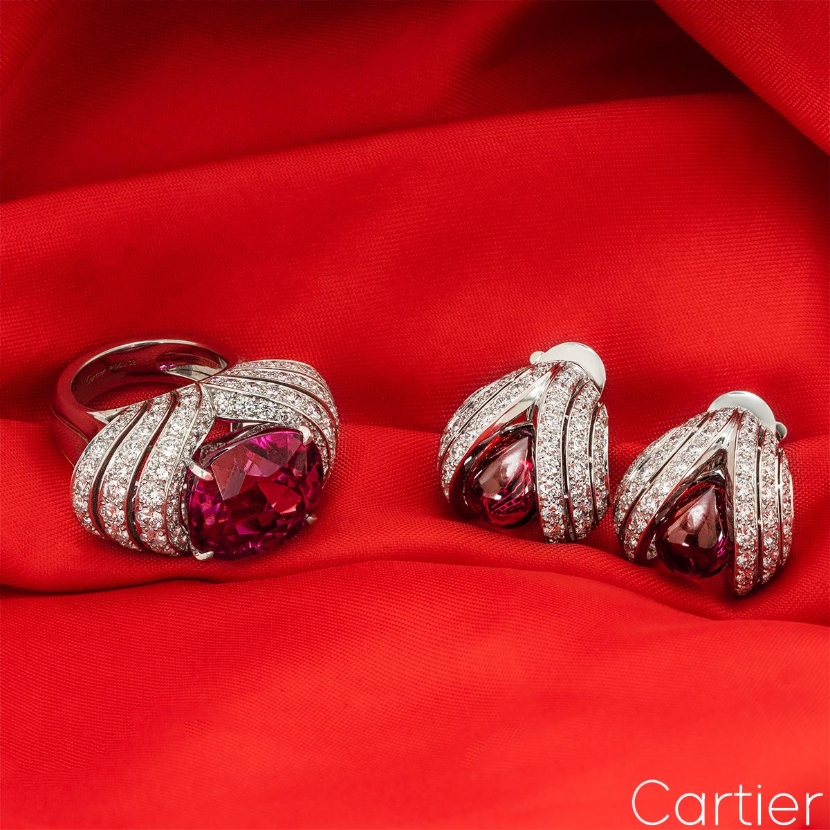A beautiful platinum Cartier rubellite and diamond jewellery suite, featuring a ring and a pair of earrings. The ring has been elegantly designed with 3 symmetrical rows on each side, set with a total of 118 round brilliant cut diamonds (4.24ct~)