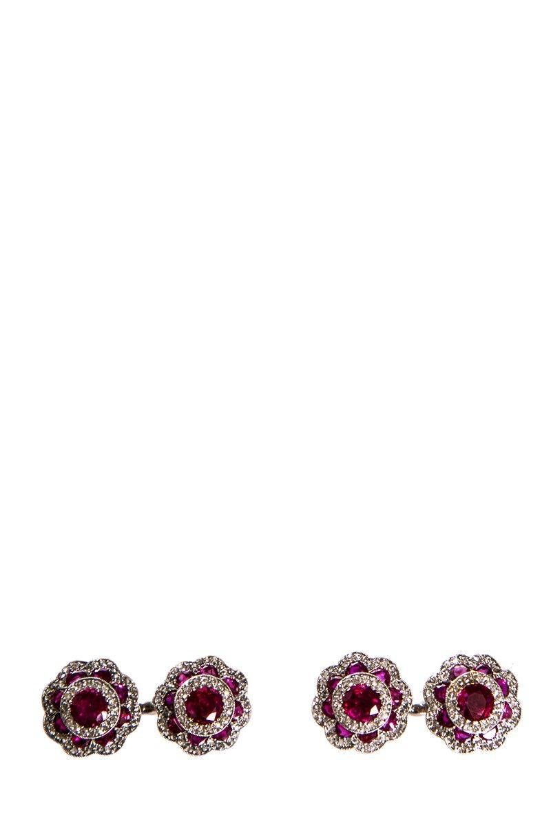 Cartier platinum ruby and diamond cufflinks. Rubies, approximately 3.40 total carat weight (center stone, approximately 2.0 carat weight and surrounding rubies, approximately 1.40 carat weight).
 
This item is previously worn with no visible signs