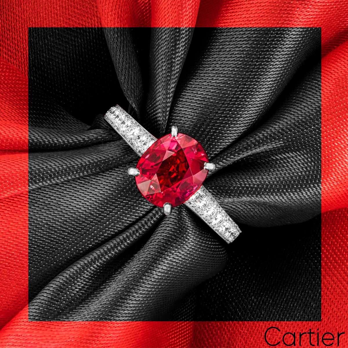 A captivating platinum ruby and diamond ring by Cartier. Set to the centre is a beautiful 2.36ct oval cut ruby from Mozambique displaying a vivid red hue often known as 'pigeon's blood' red. Accentuating the ruby are 24 round brilliant cut diamonds