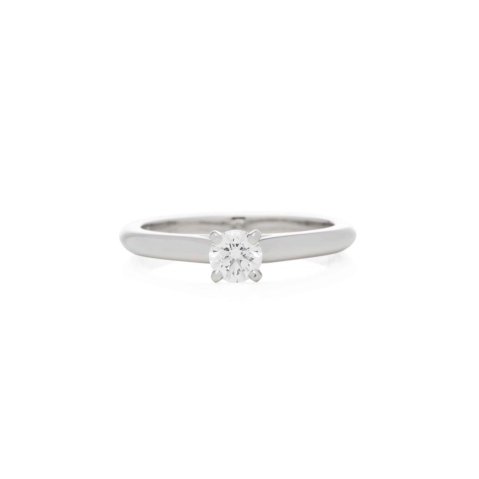 This Ring by Cartier is from their Solitaire 1895 collection and features a single Round Brilliant Cut Diamond totalling 0.37cts, clarity VS, colour G mounted in a Platinum band. UK Finger Size N 1/2, EU Size 55, USA Size 7 1/4. Complete with Xupes
