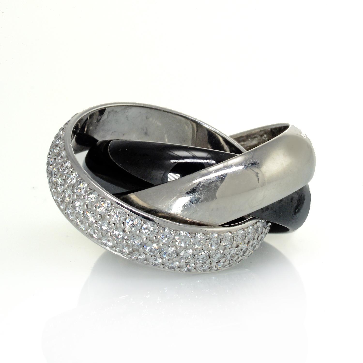 Trinity platinum Cartier ring with black ceramic and diamonds. 

METAL: platinum and ceramic
GEMSTONE(S): round brilliant-cut diamonds approx. 1.85 carats total, most F-G/VS
MEASUREMENTS: 1/2 inch at the widest section
RING SIZE: 5, Cartier size