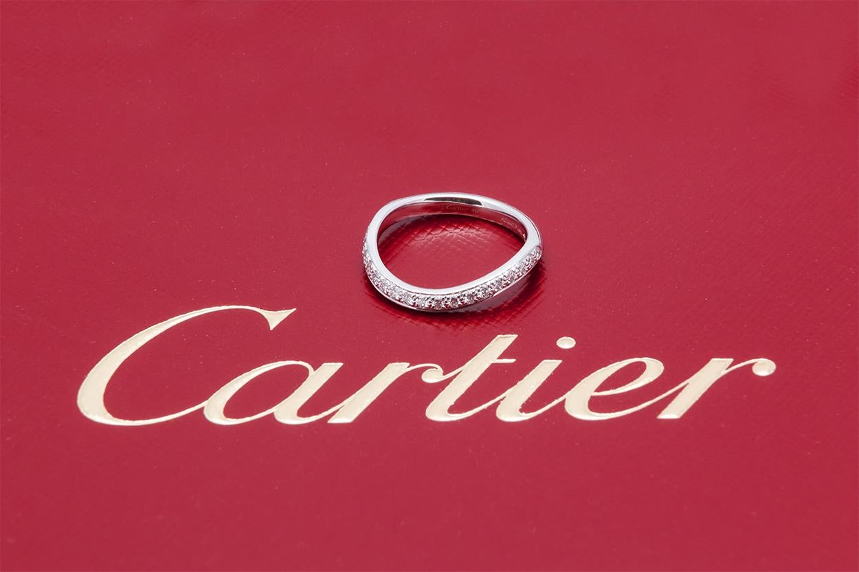We are pleased to offer this Authentic Cartier Platinum Trinity Ruban Single Row Wedding Band. It features 0.22ctw D-F/VVS-VS Round brilliant Cut Diamond set in platinum. It is a size 4.75 US (49 EU) and measures 2mm wide. It comes complete with the