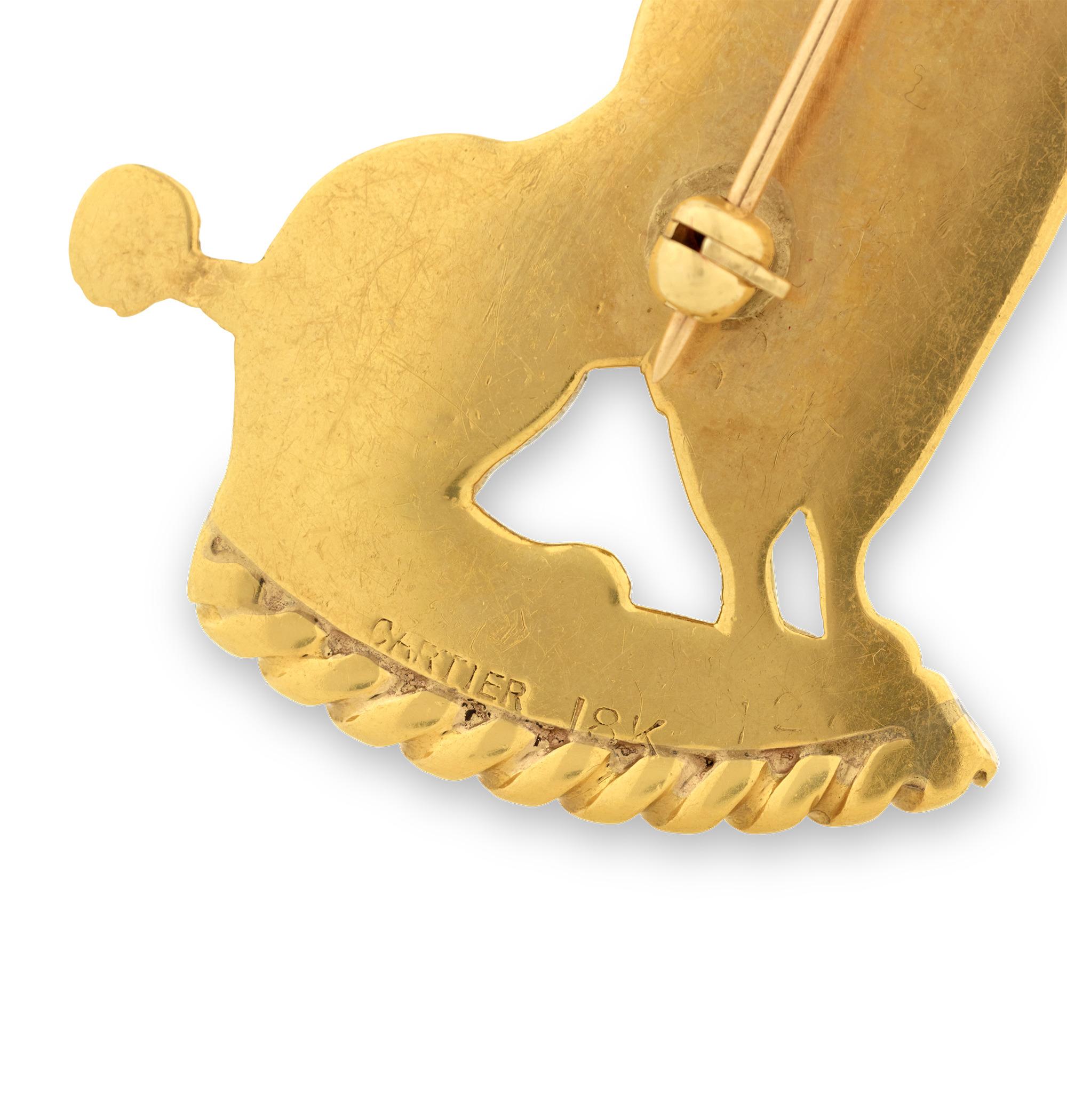 This delightful gold poodle brooch showcases the more whimsical side of the legendary French jeweler Cartier. The playful yet elegant brooch features an 18K gold poodle sitting at attention. The canine accessory is accented by a blue sapphire eye