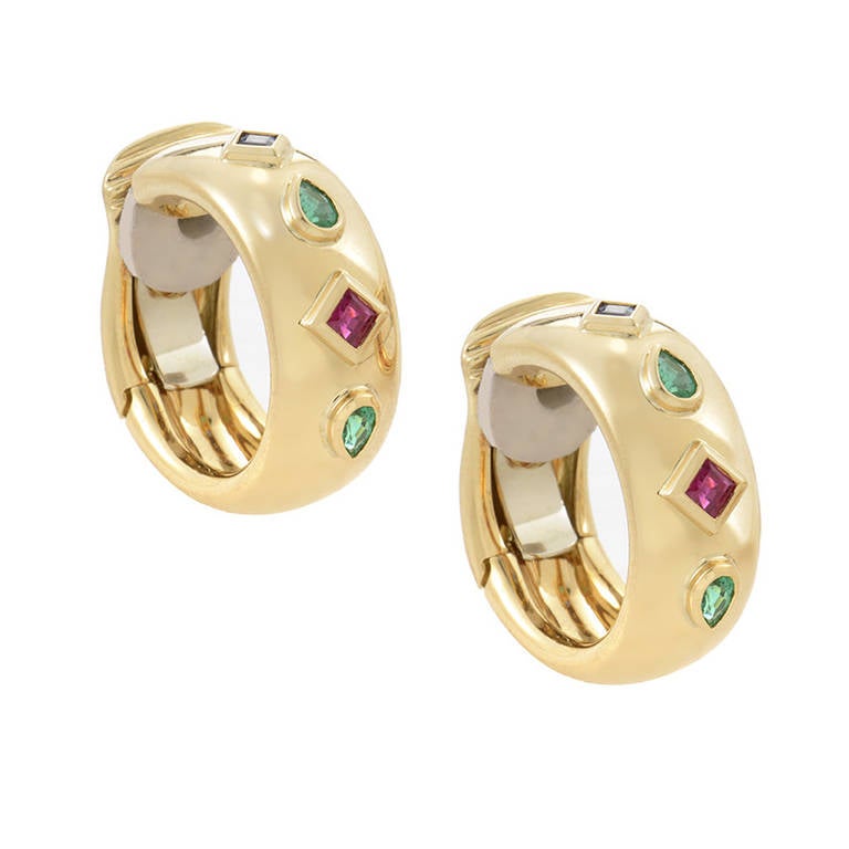 Multi-colored stones pay perfect compliment to this pair of gold earrings from Cartier. Rubies, sapphires, and emeralds provide an array of sparkle set in 18K yellow gold.