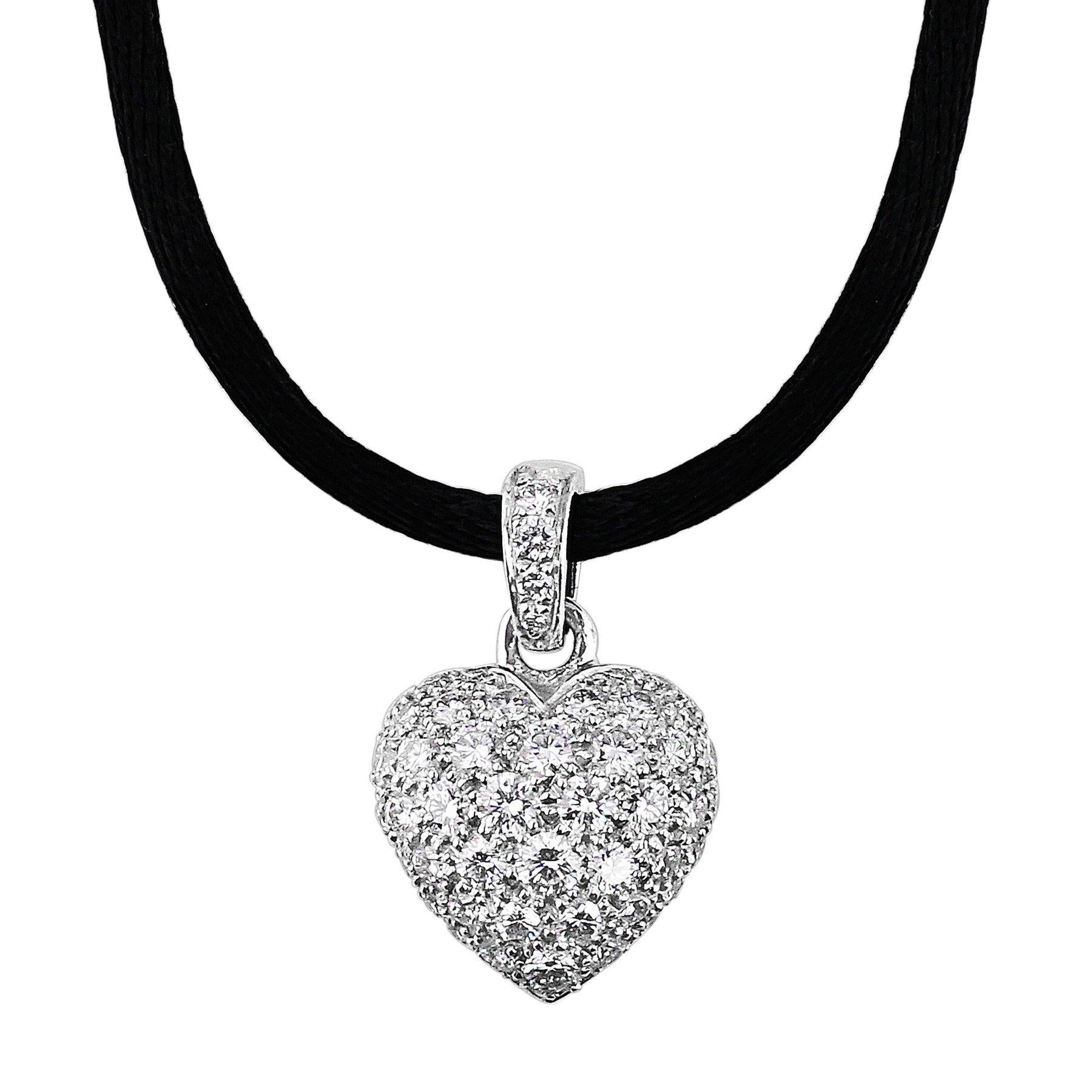 Cartier Puff Heart Diamond Necklace. 18k white gold estate Cartier puff heart pendant set with diamonds weighing approximately 1.50cttw. The pendant is set upon a black cord.
