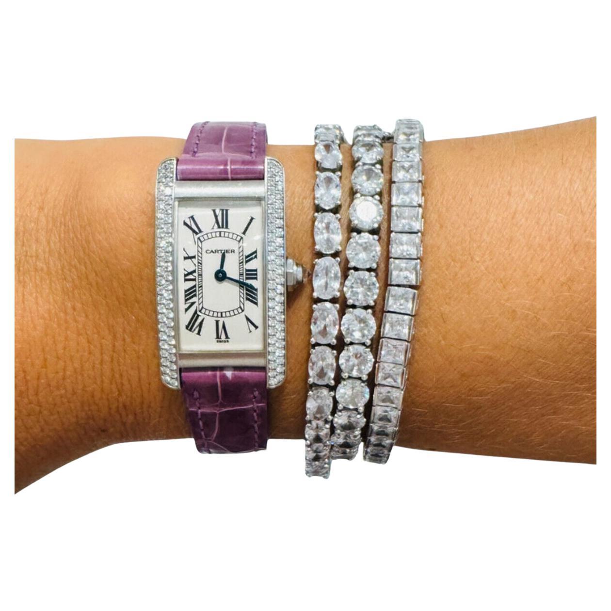 Pre-Owned Cartier Tank Americaine (WB702651) self-winding automatic watch, features a 23mm x 41mm 18k white gold case with a diamond bezel surrounding a silver dial on a purple alligator strap with an 18k white gold deployant buckle. 
Functions