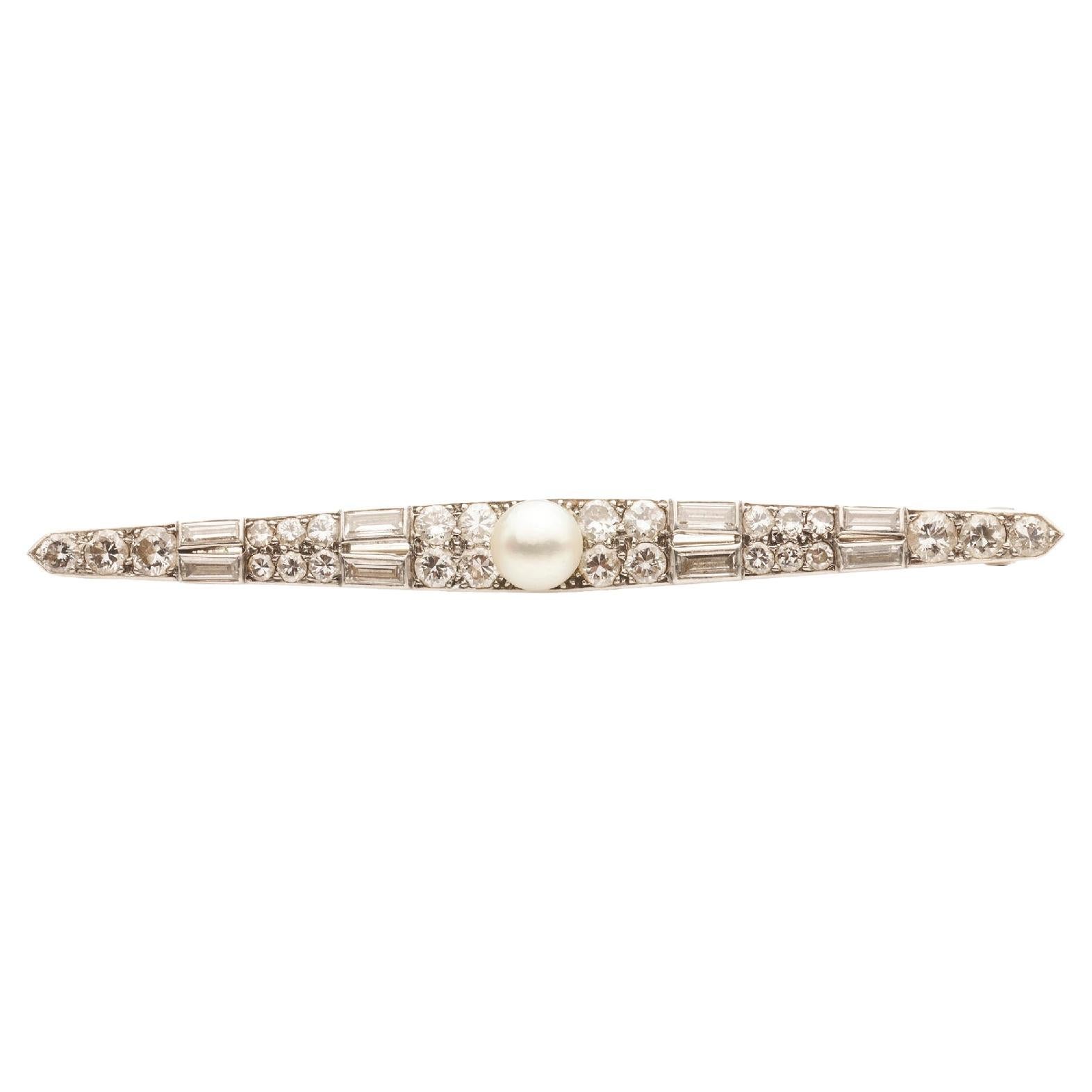 Cartier  Art Deco diamond and pearl bar brooch, centred with a button-shaped pearl of 5.9 mm, to an elongated navette bar encrusted with old European-cut and baguette-cut diamonds, with an estimated total weight of 1.12ct.

Brooch  fittings to the