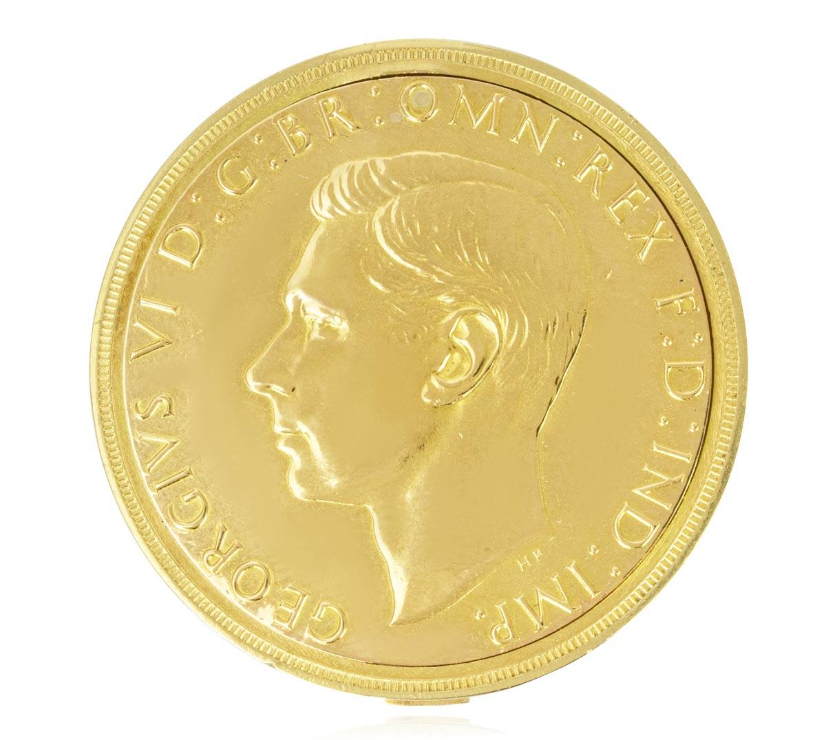 Cartier. A Rare and Highly Important King George VI Gold Five Pound Coin Watch, C1937.

Dial: The plain silver dial signed Cartier with black Roman numerals and outer minute track with blued steel moon hands complimenting the dial