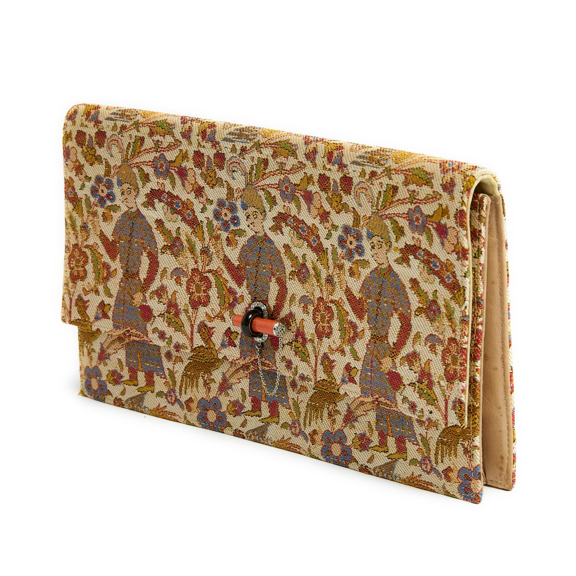 Cartier evening clutch circa 1920 entirely embroidered in multicolored silk with Persian motifs, the clasp in white gold, brilliant-cut diamonds and coral (rubrum, not subject to CITES), yellow silk interior, natural leather gussets. Width 24 cm x
