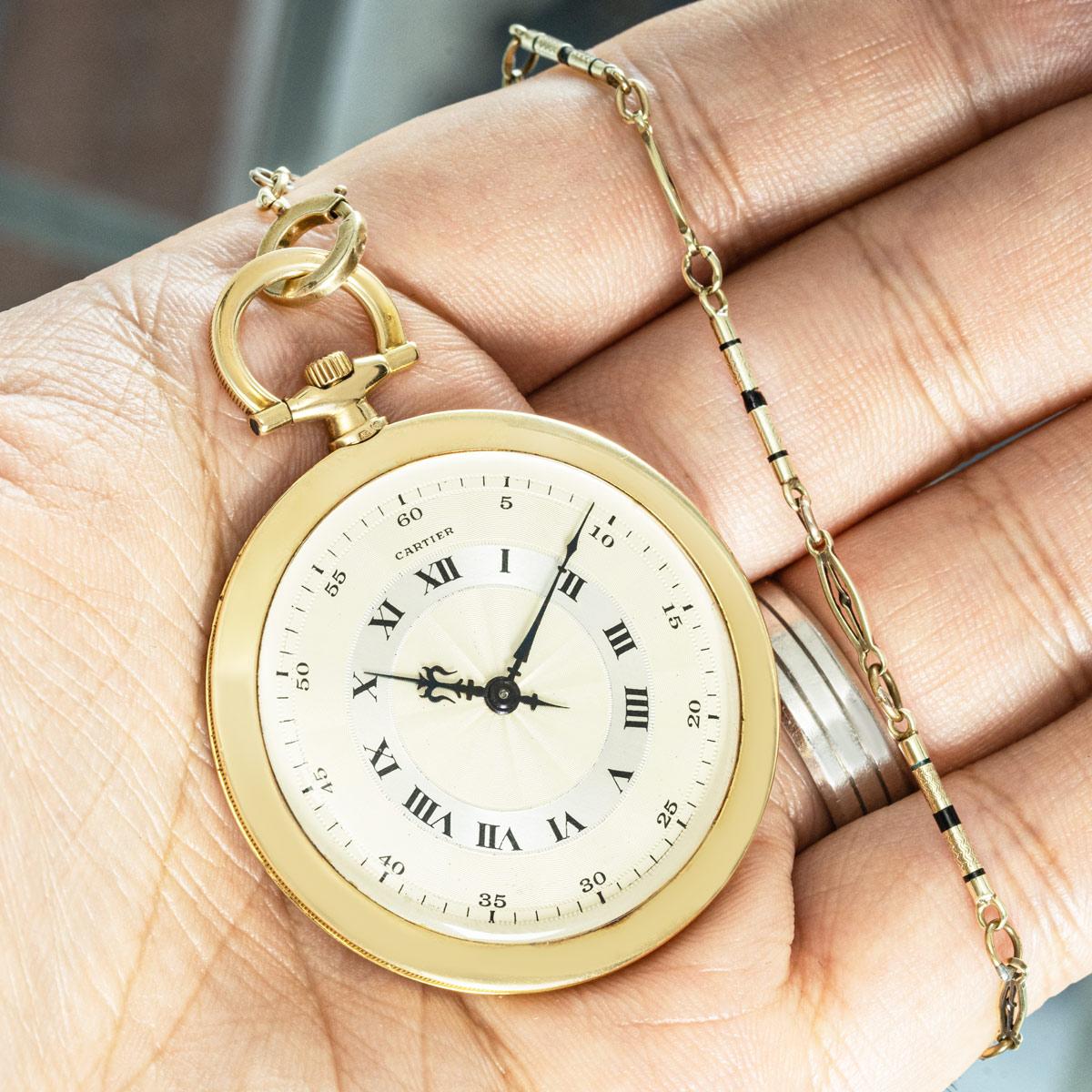 Cartier. A Rare Slim 18ct yellow Gold Keyless Lever Pocket Watch with a matching gold and enamel dress chain C1940.

Dial: The superb two-tone silver engine turned dial features Roman numerals in a concentric dial and an outer minute track with