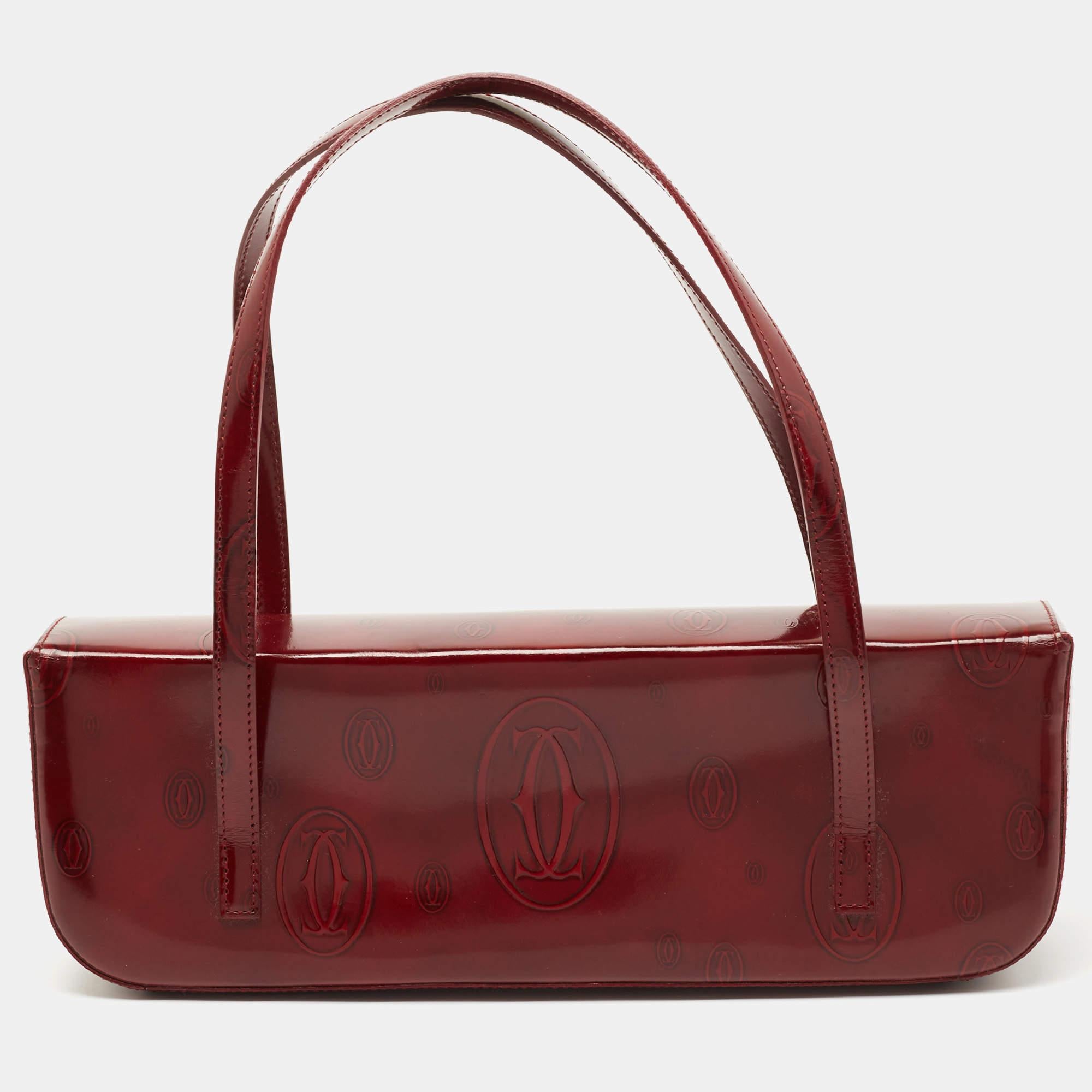 Show your love for Cartier with this shoulder bag from Cartier’s Happy Birthday Collection. This bag is crafted from glossy leather and features a petite silhouette and dual handles. The interior is lined with fabric.

