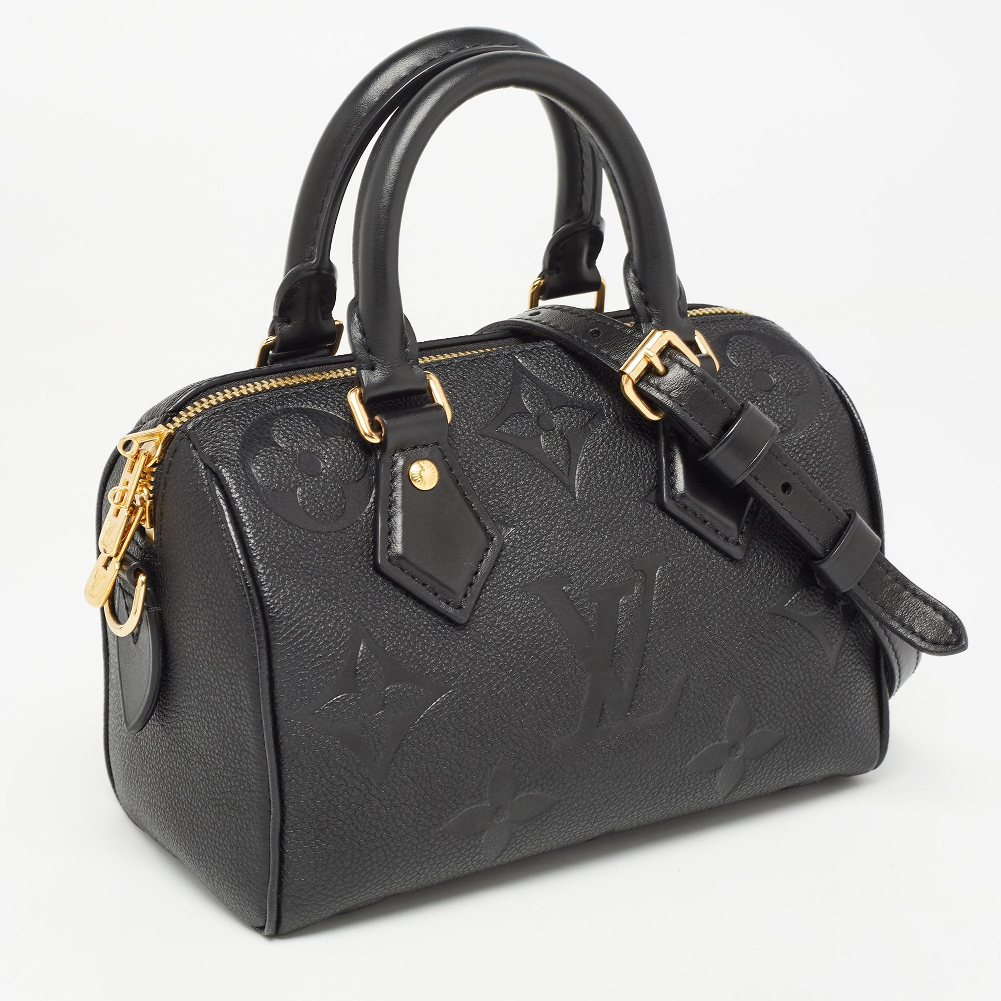 This Cartier beauty arrives in a gorgeous shape and design. It has a leather construction with logo detailing and two handles on top. The zipper secures the fabric interior and overall, the bag looks ready to lift your classic style.

