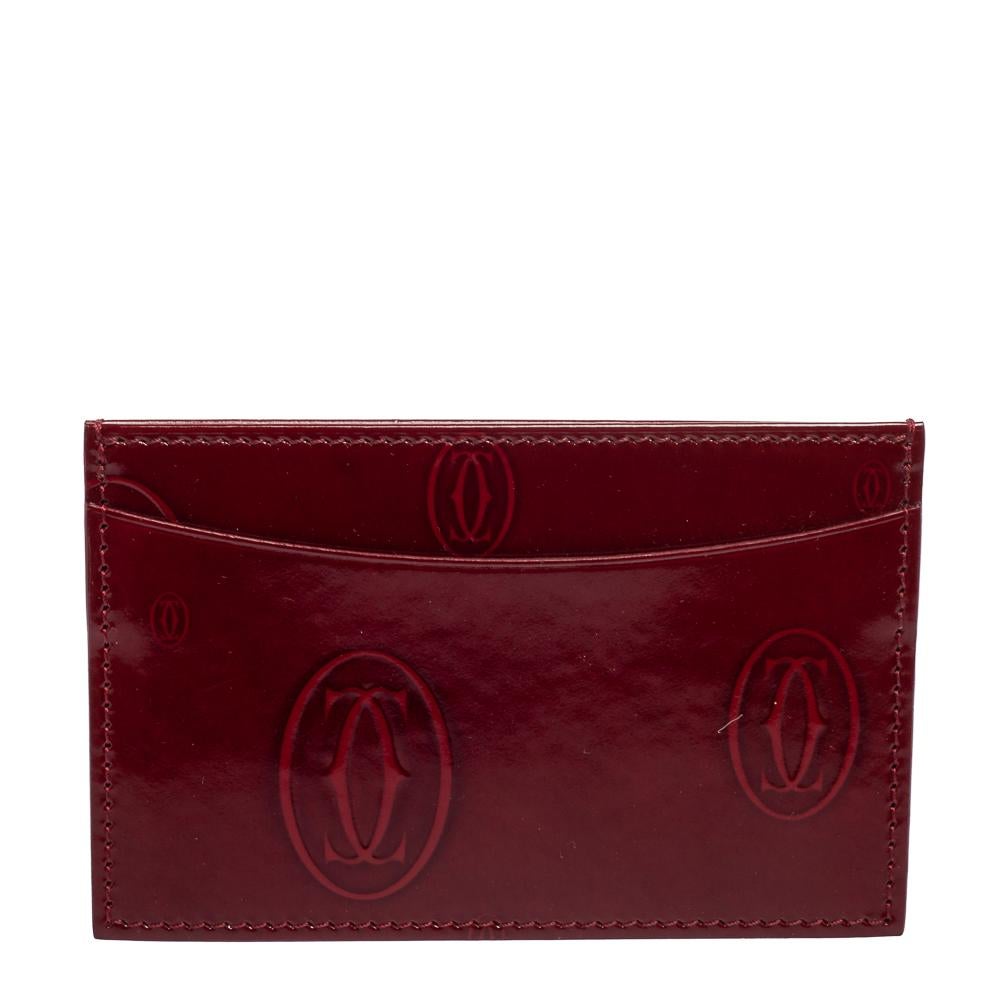 This designer card holder by Cartier is a statement piece. Crafted from signature-detailed patent leather in red, it comes with lined card slots at the front and back.

