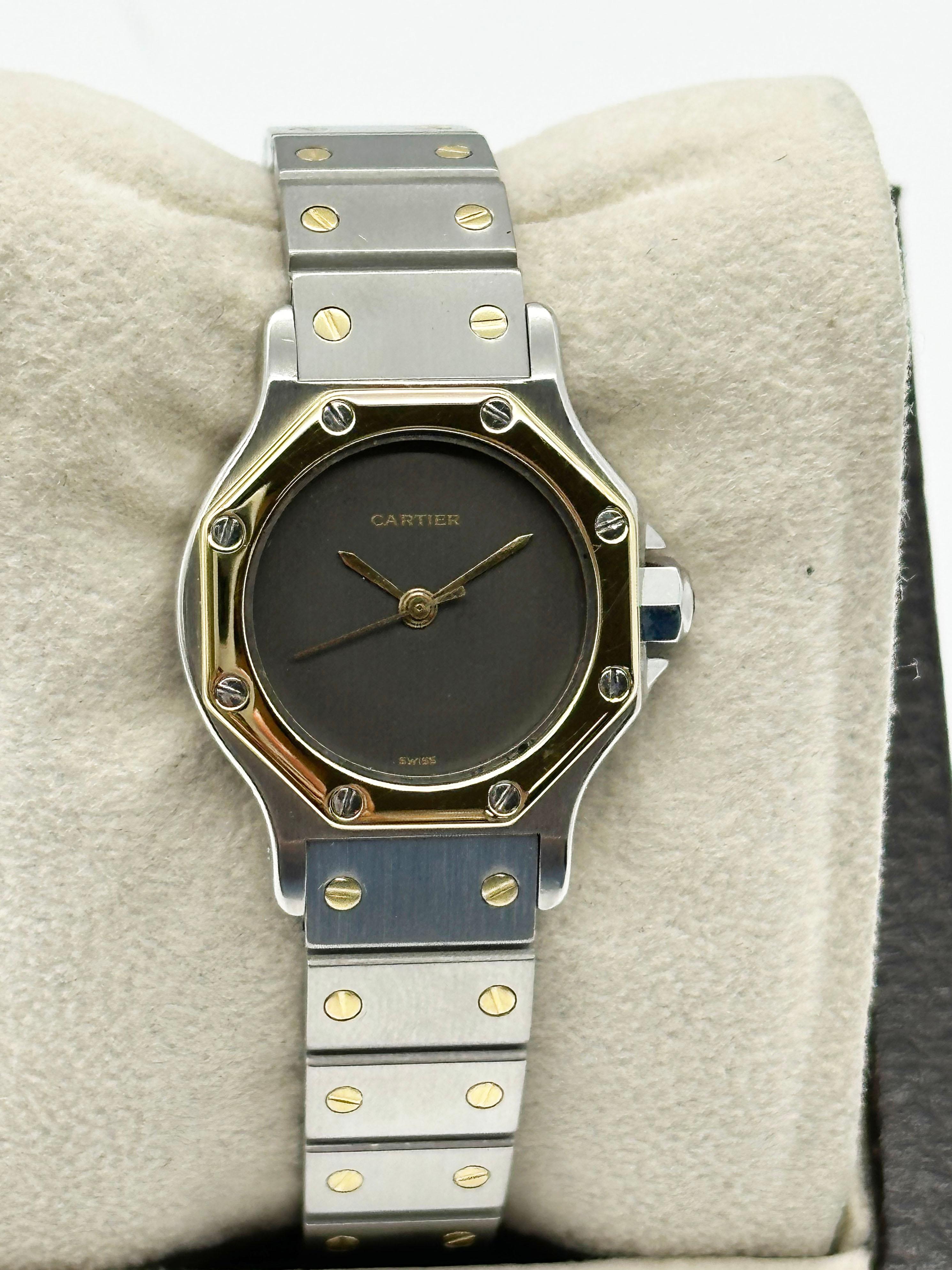 Style Number: 0907

 

Model: Ladies Santos Octagon 

 

Case Material: Stainless Steel 

 

Band: 18K Yellow Gold & Stainless Steel 

 

Bezel:  18K Yellow Gold

 

Dial: Grey

 

Face: Sapphire Crystal 

 

Case Size: 25mm

 

Includes: 

-Elegant