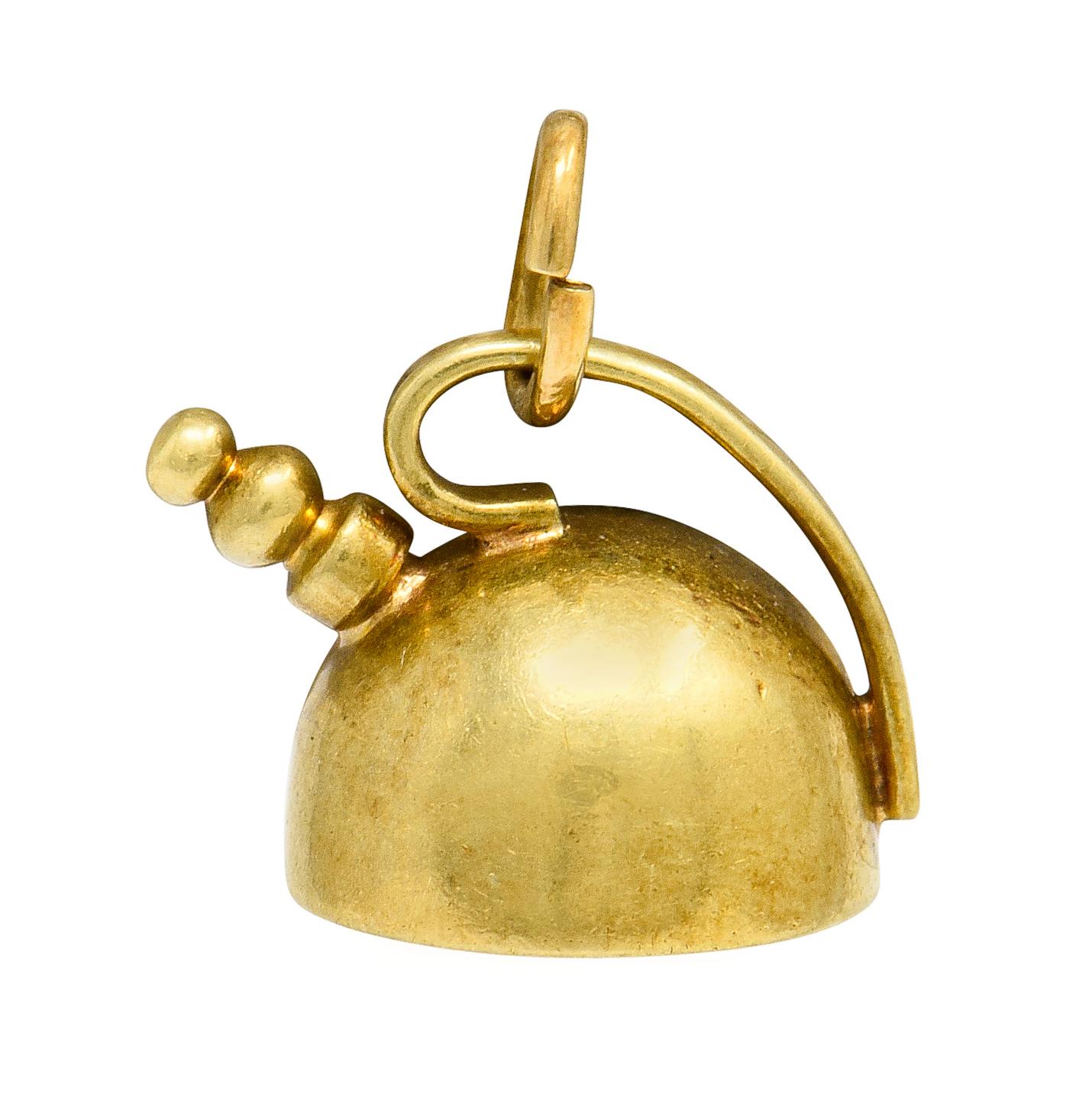 Charm designed as a stylized tea kettle

With gold beading as spout and a sleek curved handle

Completed by jump ring bale

Numbered and fully signed Cartier

Stamped 14 for 14 karat gold with maker's mark for Sloan & Co. for Cartier

Circa:
