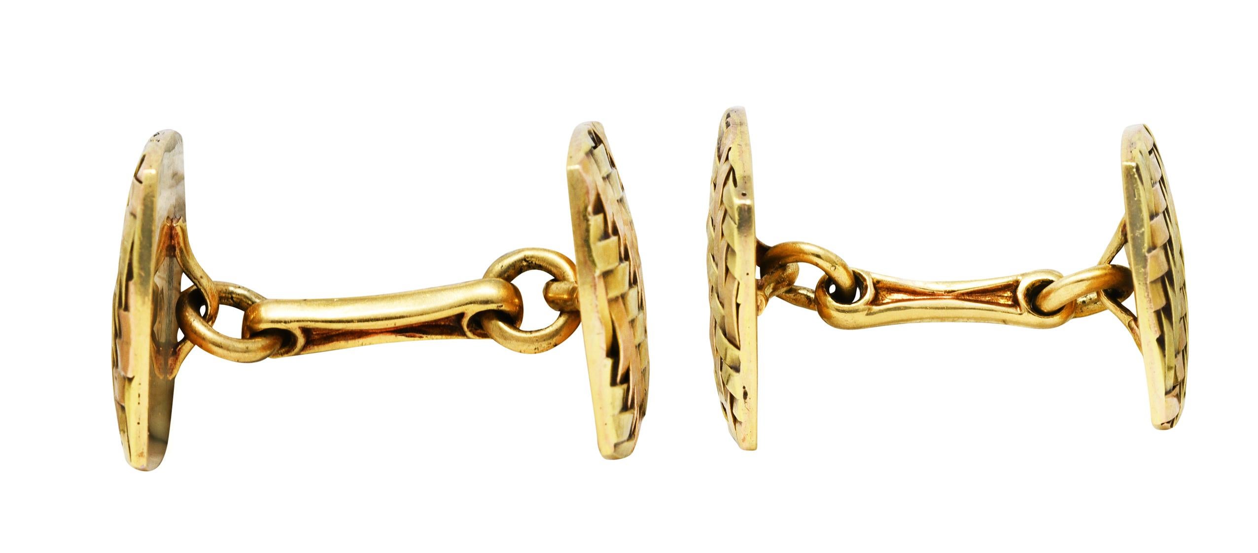 Link style cufflinks terminate as yellow and rose gold cushion forms

With a deeply grooved basket-weave motif throughout

Stamped 14k for 14 karat two-tone gold

Fully signed Cartier with maker's mark

Circa: 1940's

Length: 1 3/16 inches

Cushions