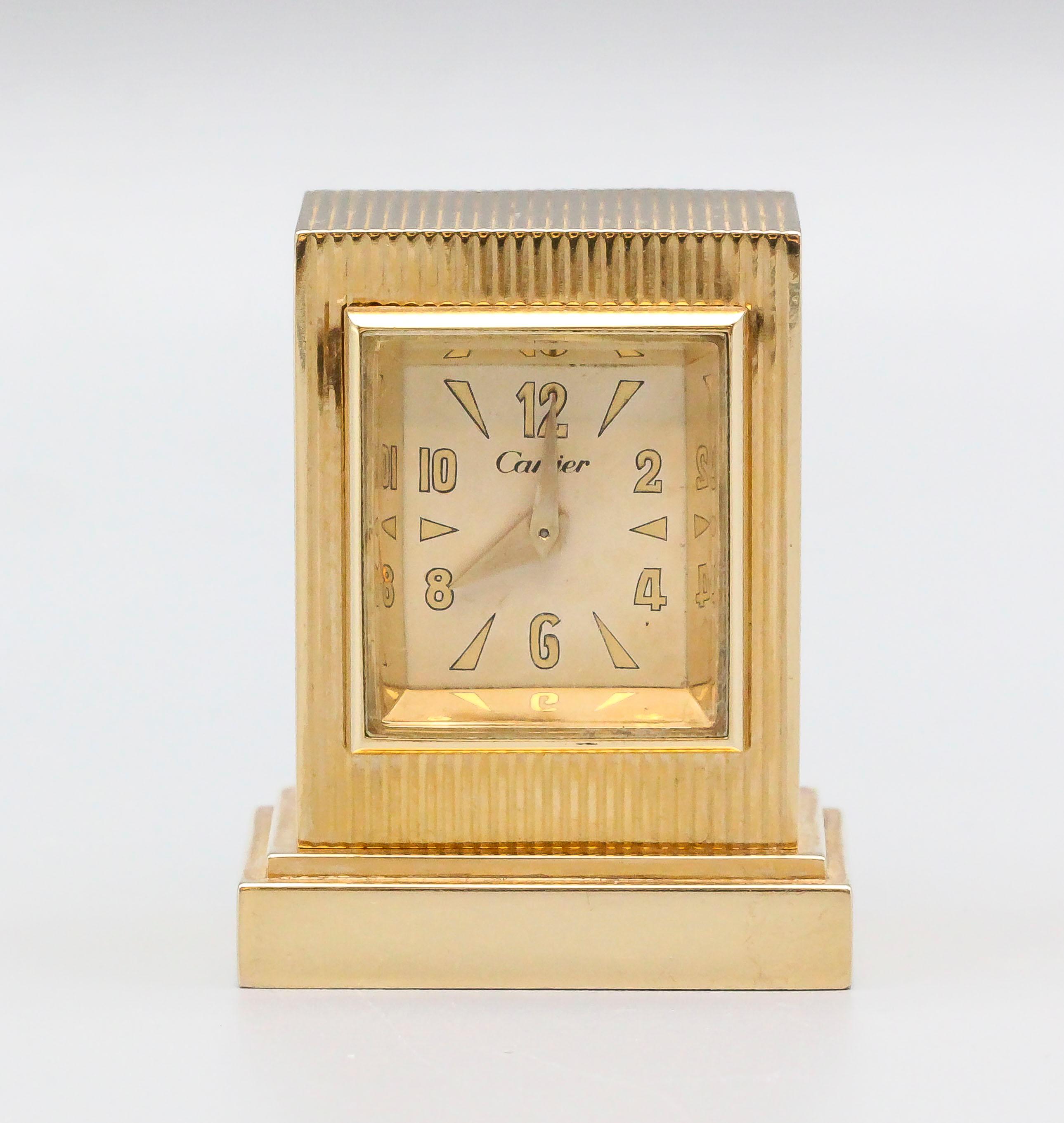 Rare and unusual Retro Era  14K yellow gold desk clock by Cartier, circa 1940s. It features a key winding mechanism.  