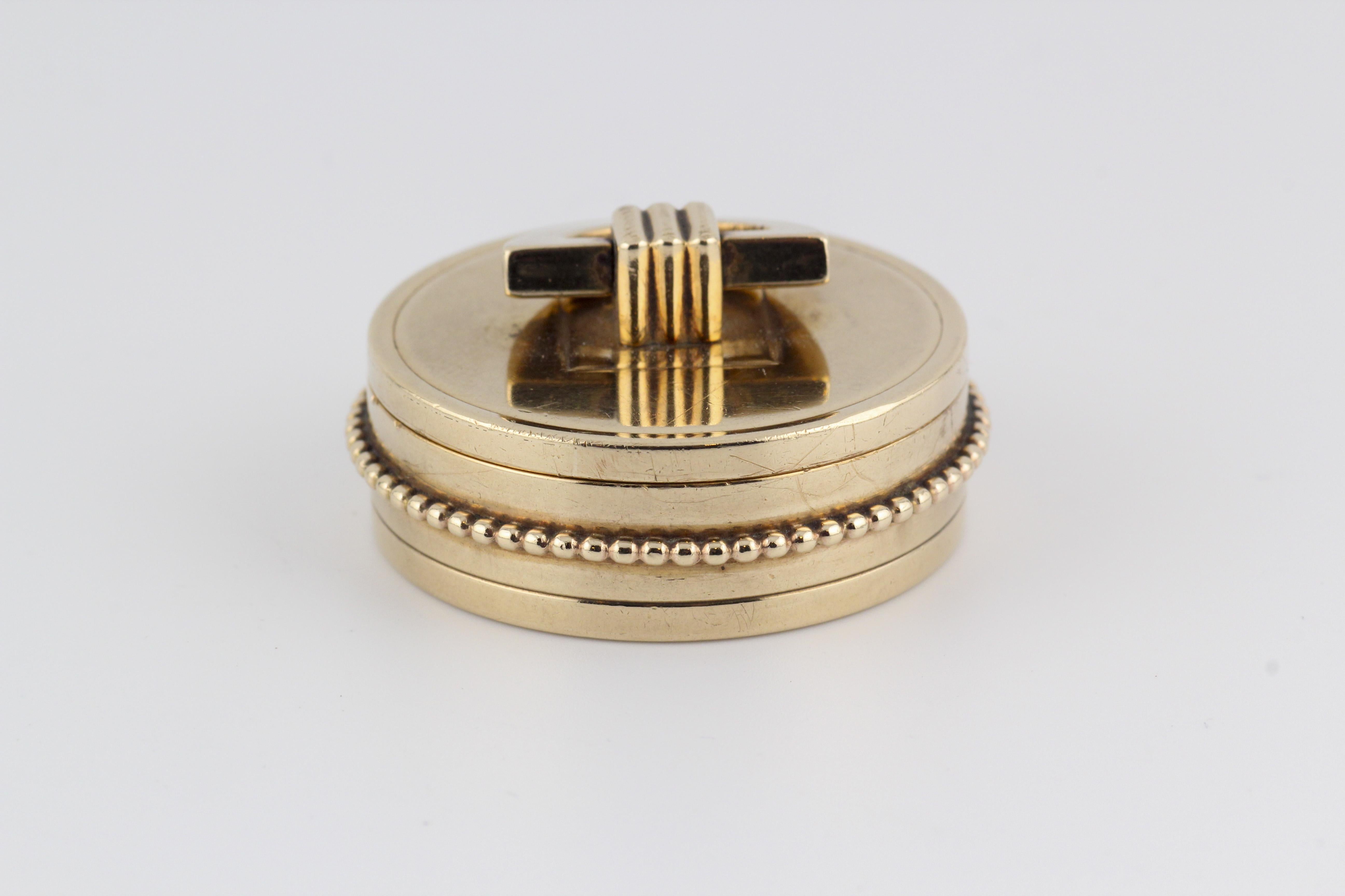 Embrace the epitome of elegance and functionality with this exquisite Cartier London 9K Yellow Gold Round Pill Box. Meticulously crafted, this pill box is a testament to the enduring legacy and impeccable craftsmanship synonymous with the esteemed