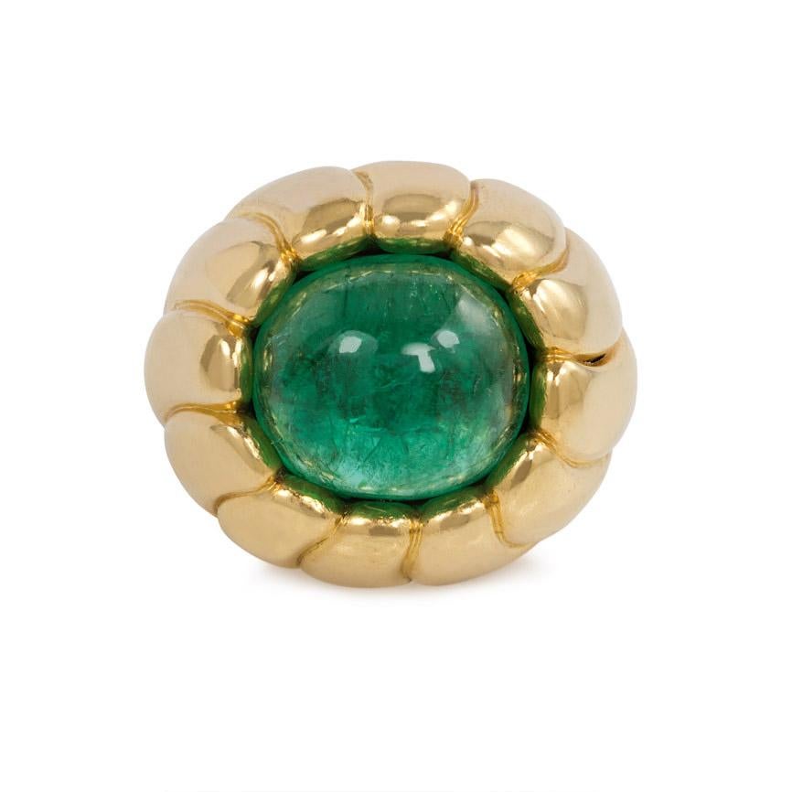 A Retro fluted gold and cabochon emerald cocktail ring of bombé design, in 18k.  Cartier, Paris #05148.  Approximately 9.04 ct. emerald

Current ring size: 4.25; minimal re-sizing possible