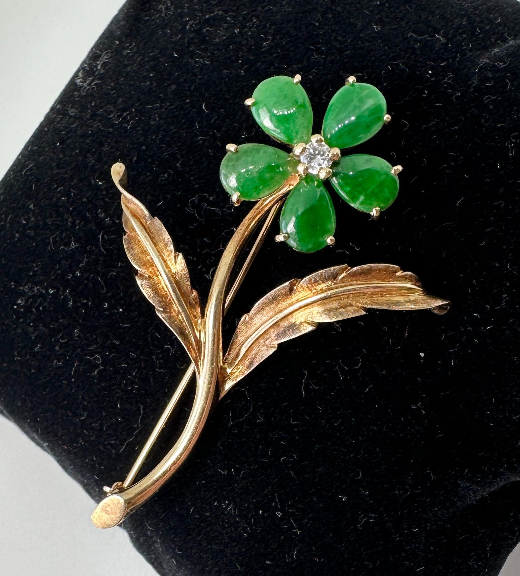 This is a gorgeous and rare antique Cartier Jade and Diamond Flower Brooch Pin in 14 Karat Gold.  The stunning jewel is an Antique brooch by Cartier dating to the Mid-Century Modern period.  Cartier and Jade have been a special pairing since the Art