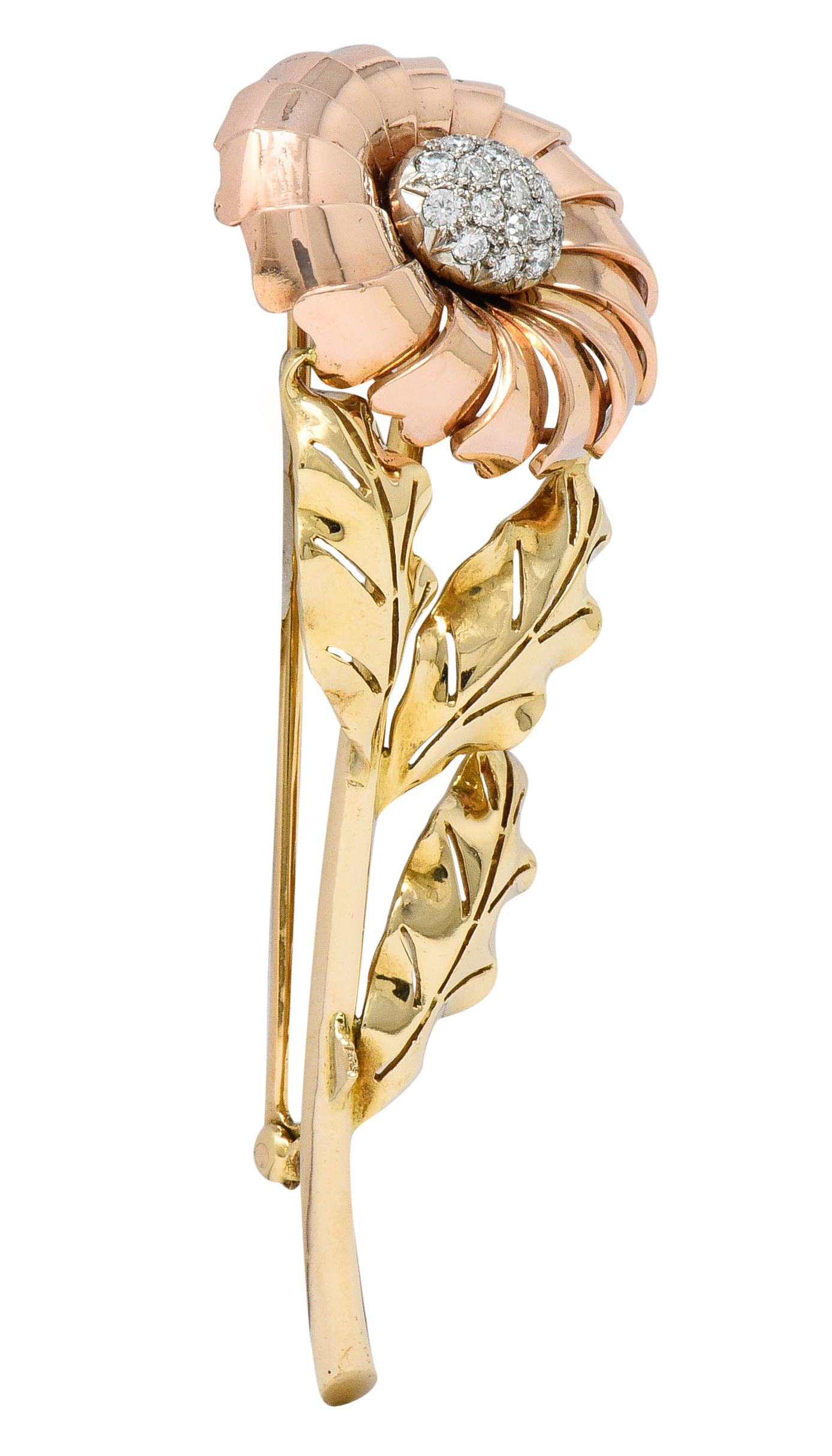 Brooch is designed as a tri-gold flower with an elongated yellow gold stem

Petals dramatically tier and radiate as polished rose gold

Accented by three stylized and pierced leaves branching from stem; polished green gold

With a pavè center of