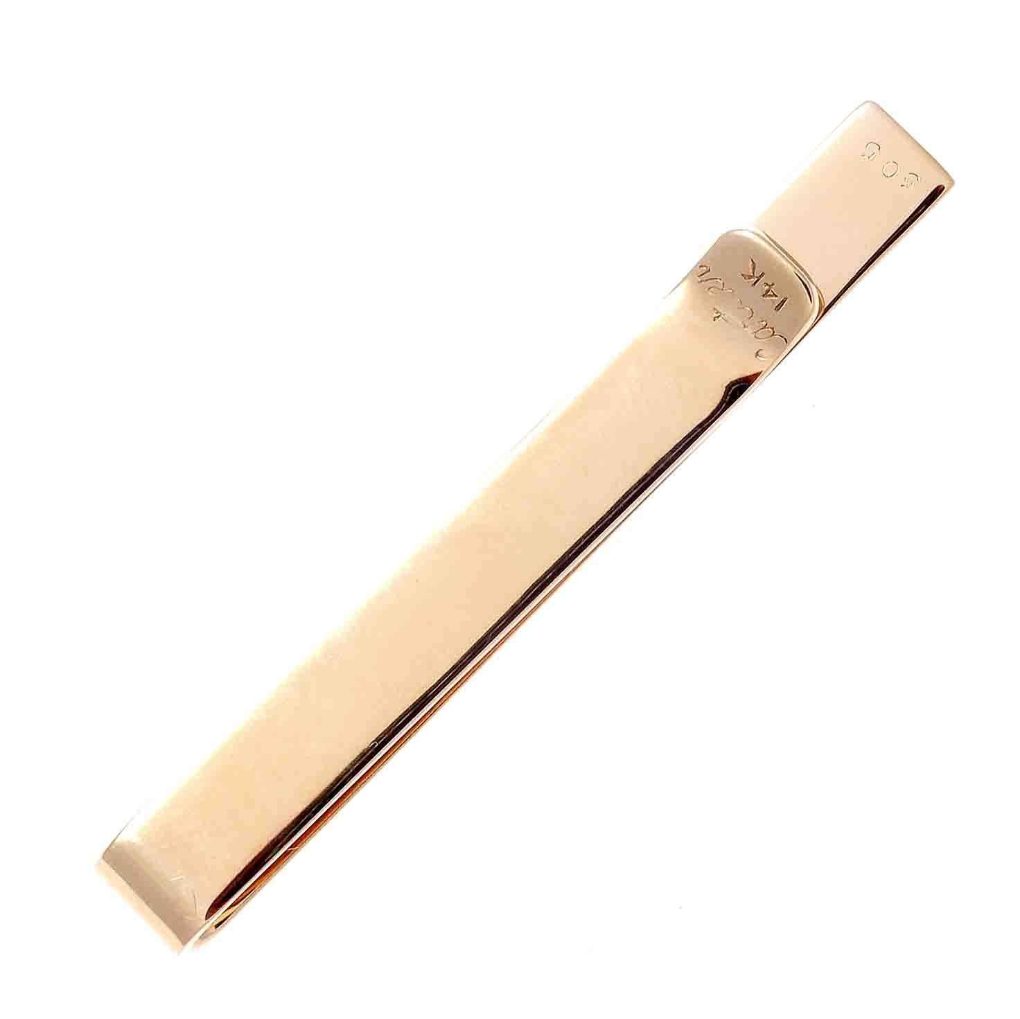 Expert craftsmanship with meticulous design even in their smallest of creations. Hand crafted in 14k gold with diagonal ridges cascading down the clip. Signed Cartier.