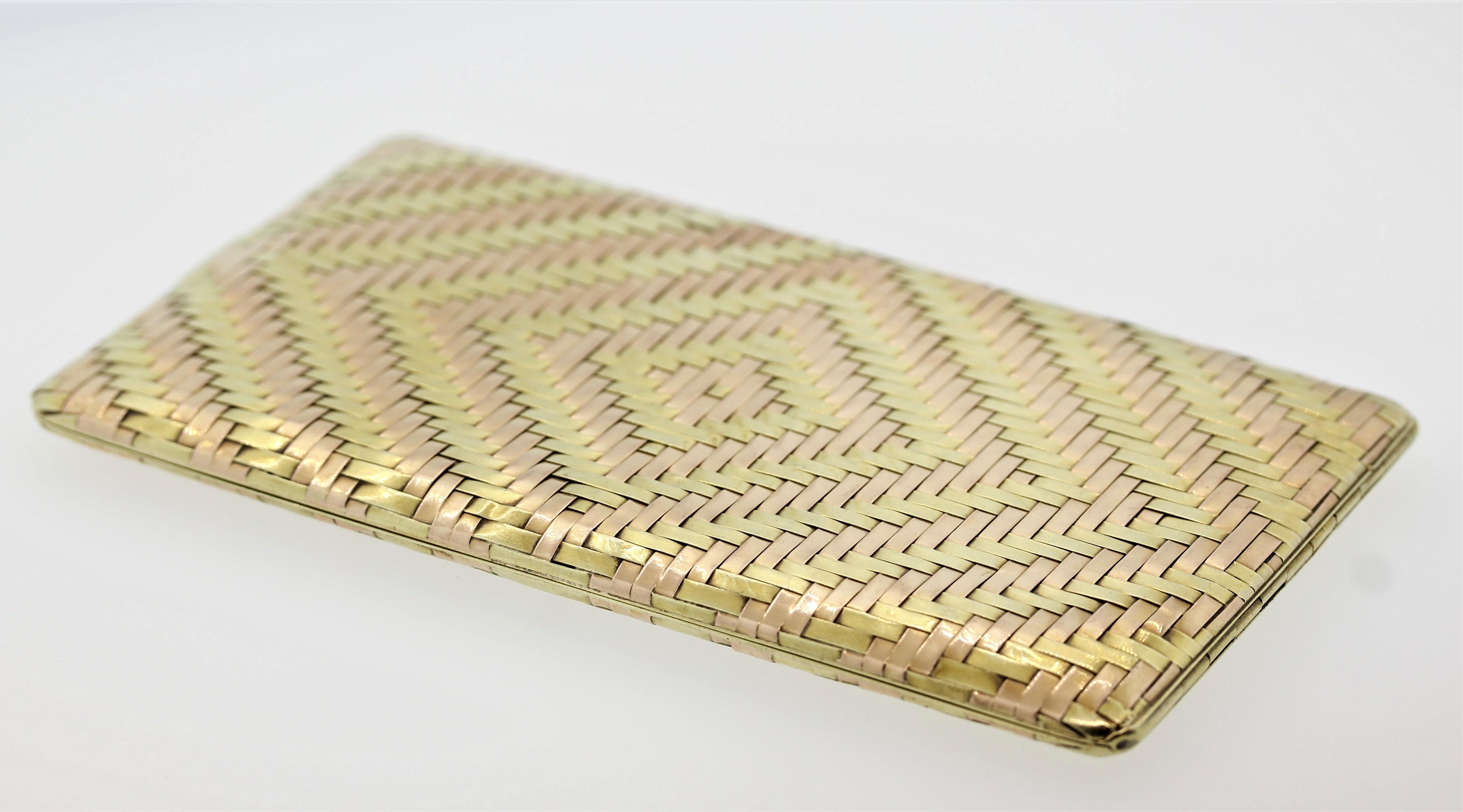 A hand crafted cigarette case, circa 1940, from Cartier. It features 14k woven green and rose gold that form a lovely pattern. It opens to reveal a sculpted gold clasp to hold down your product. Slight toning to the metal, the inside of the closure
