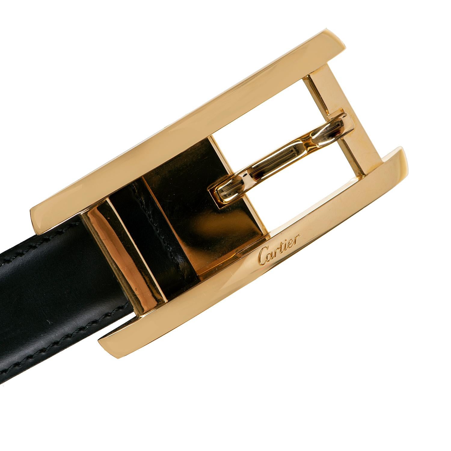 In 'As New' condition this beautifully crafted luxury belt by Cartier of Paris, is reversible, giving two colour options of black or dark brown. The gold buckle has the Cartier signature and the belt measures 35in. (89cm) long