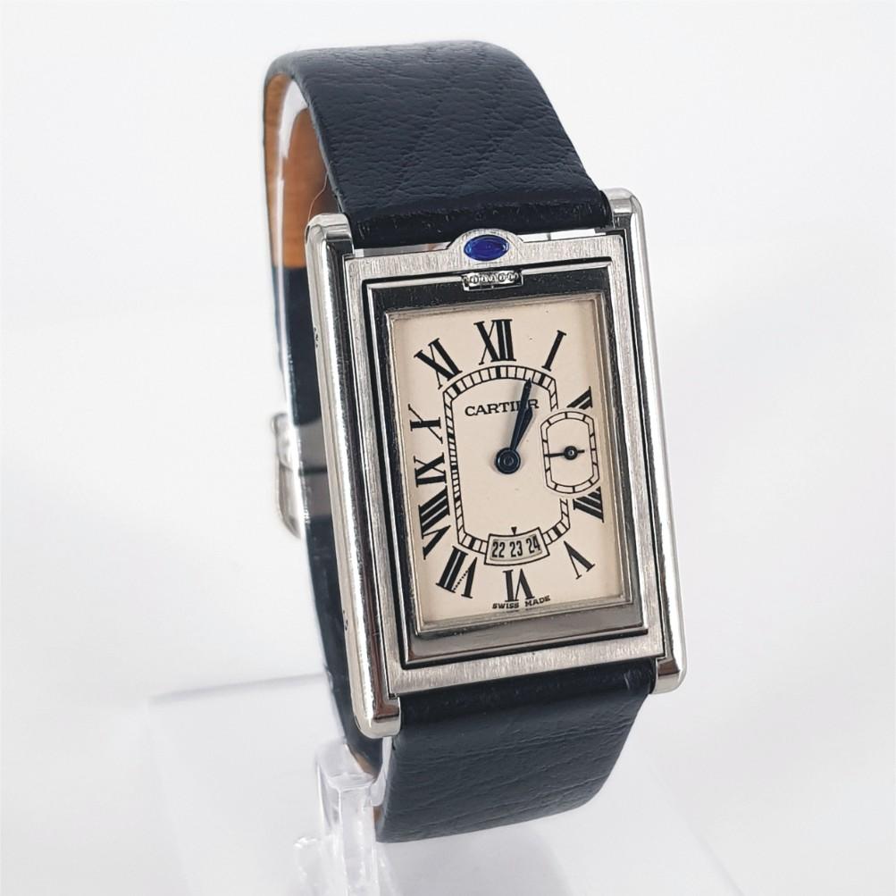 Cartier Reverso Watch – Quartz in Excellent condition. 
Model Number: 557401CD & Serial Number: 2522 
Year: 2010 -
Stainless Steel Case measuring 26mm x 39mm x 5mm with a Cream Dial & Leather Strap measuring 50mm.
