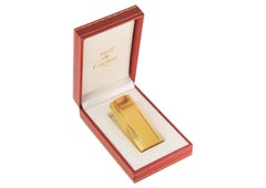 Briquet Cartier en plaqué or 18 carats à motif nervuré, dans son coffret d'origine Cartier