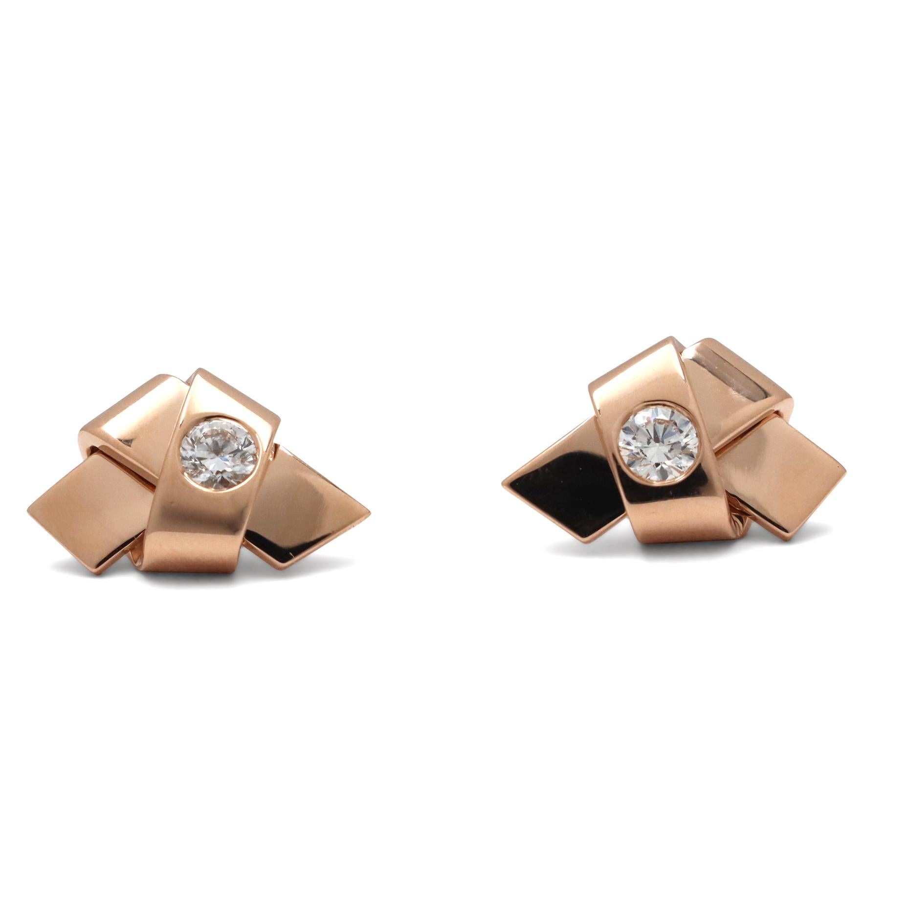 Authentic Cartier 'Ribbon Knot' earrings crafted in 18 karat rose gold featuring two round brilliant cut diamonds weighing an estimated 0.30 total carat weight (G color, VS clarity). Signed Cartier, 750, with serial number and hallmarks. The