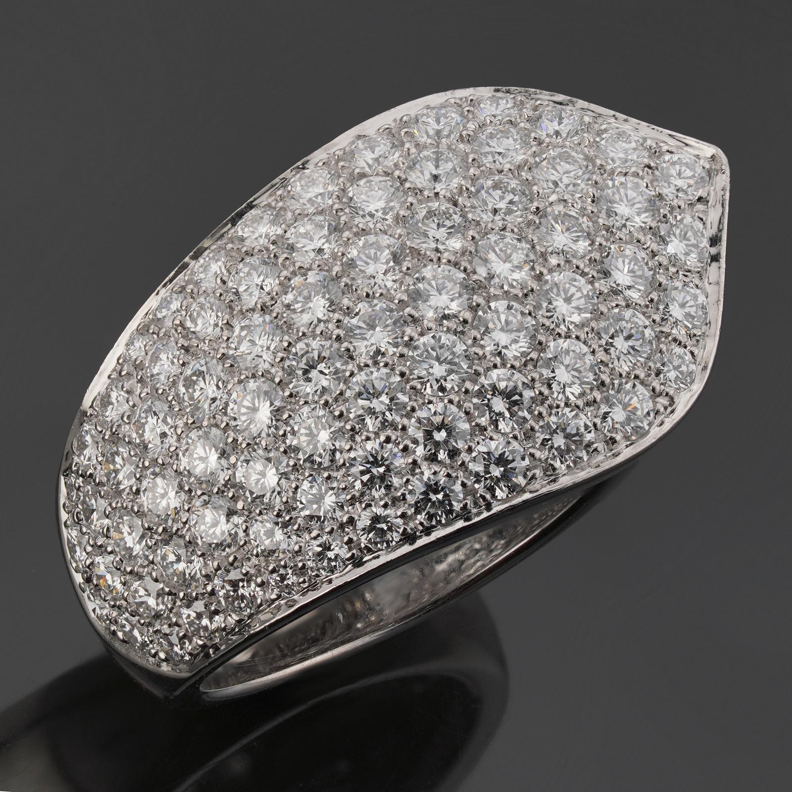 This gorgeous Cartier ring features a chic ribbon design crafted in 18k white gold and pave-set with 75 round brilliant-cut E-F-G VVS1-VVS2 diamonds weighing an estimated 4.0 - 4.50 carats. Made in France circa 2010s. Measurements: 0.62