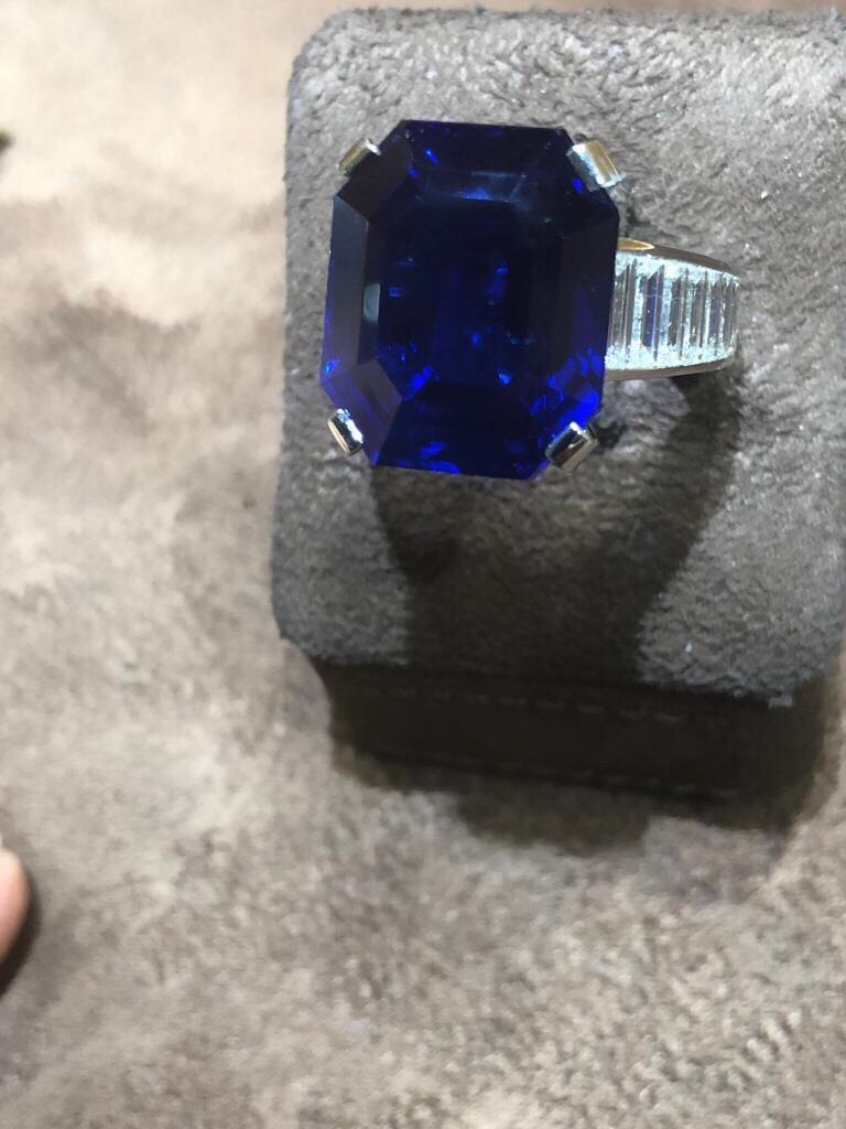 Ring in platinum Cartier set with diamonds baguettes on the shoulders , in the center a beautiful royal blue sapphire emerald cut of 20 carats with a certificat SSEF stating that the stone is natural unheated. The ring is signed, number with all