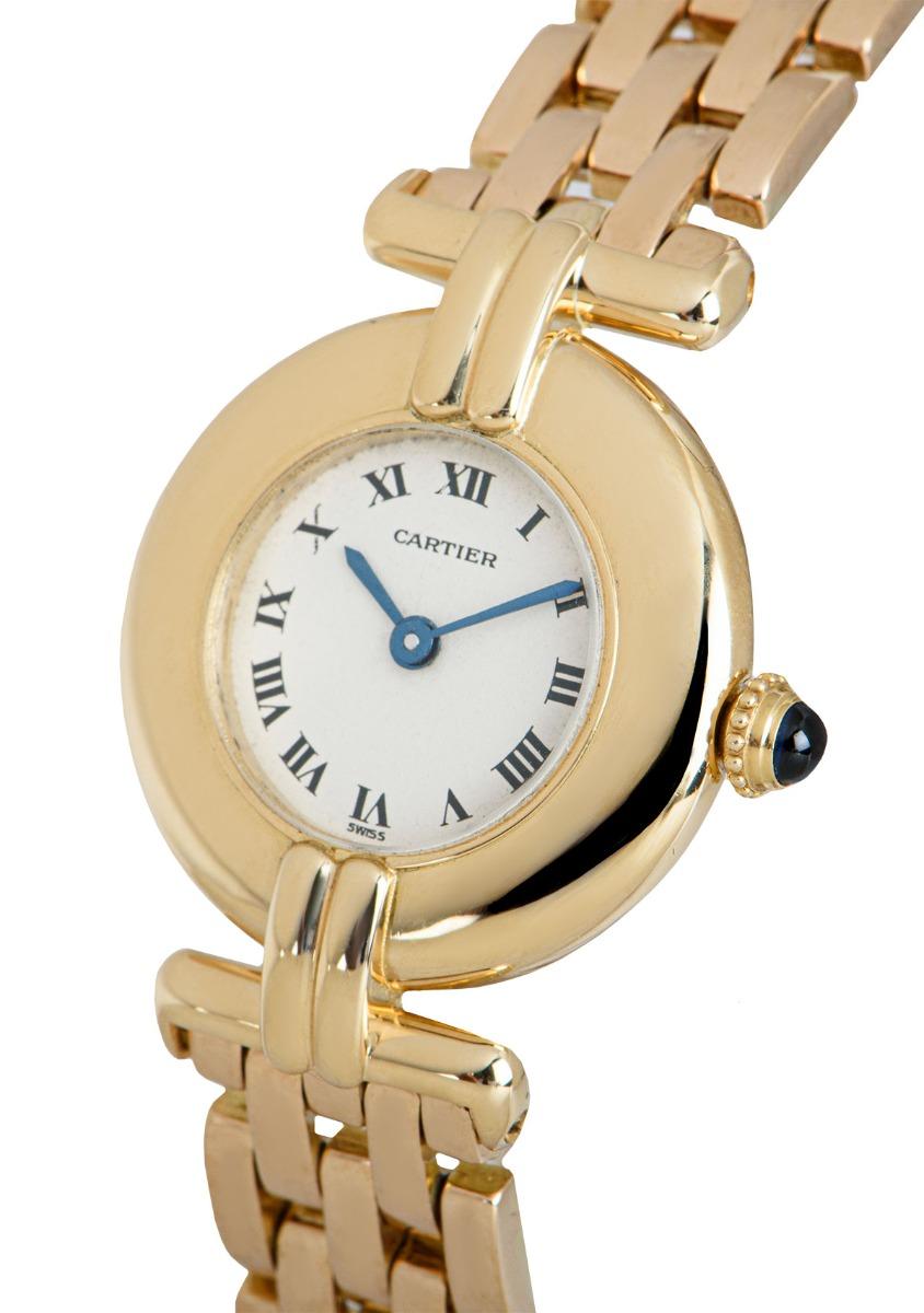 A 24 mm 18k yellow gold Rivoli women's wristwatch, by Cartier.

Featuring a silver dial with roman numerals and blue steel hands, an 18k yellow gold bracelet with a concealed double deployant clasp, sapphire crystal, and a quartz movemeent.

The