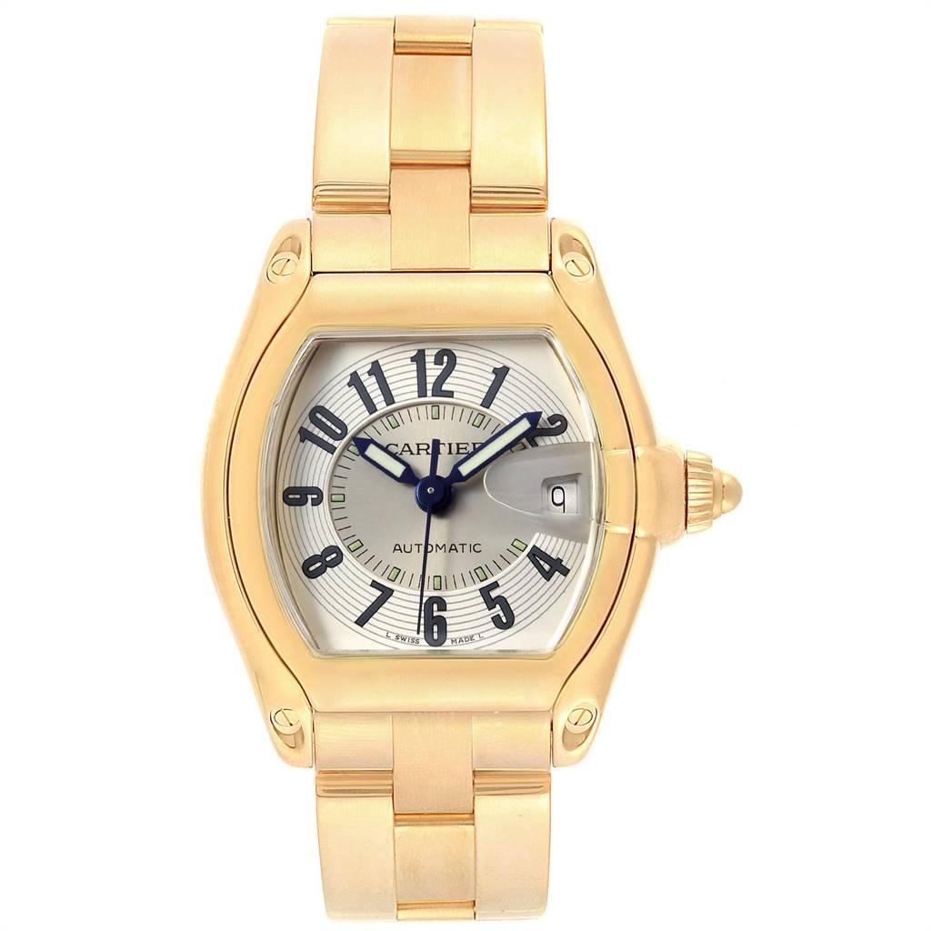 Cartier Roadster 18K Yellow Gold Large Mens Watch W62005V1. Automatic self-winding movement. 18K yellow gold tonneau shaped case 37 x 44 mm. Scratch resistant sapphire crystal with cyclops magnifying glass. Silver sunray effect dial with black