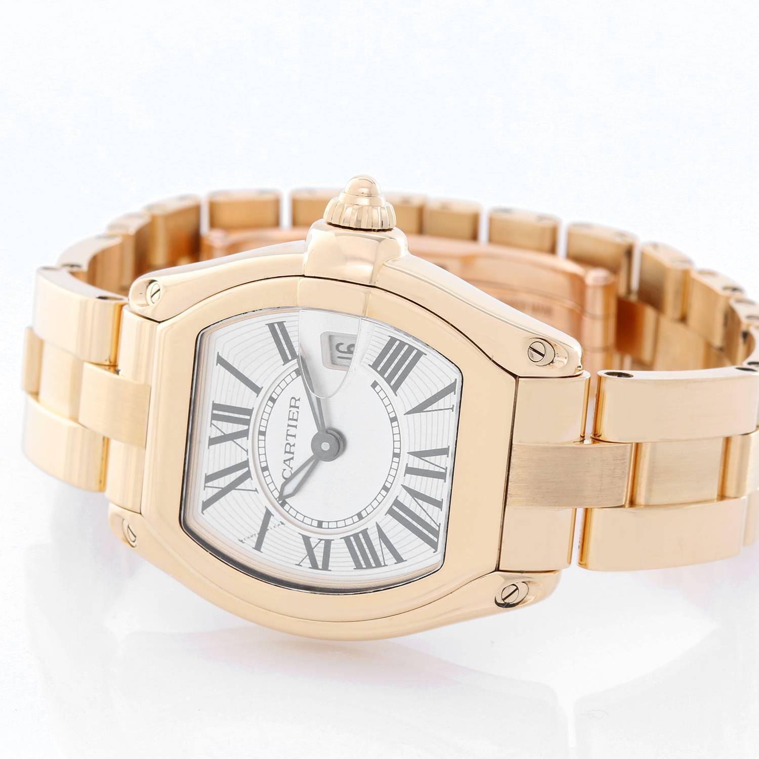 Cartier Roadster 18k Yellow Gold W62018V1 -  Quartz. 18k yellow gold tonneau style case (31mm x 37mm). Silvered guilloche dial with black Roman numerals; date at 3 o'clock. 18k yellow gold Cartier bracelet with deployant clasp. Pre-owned with