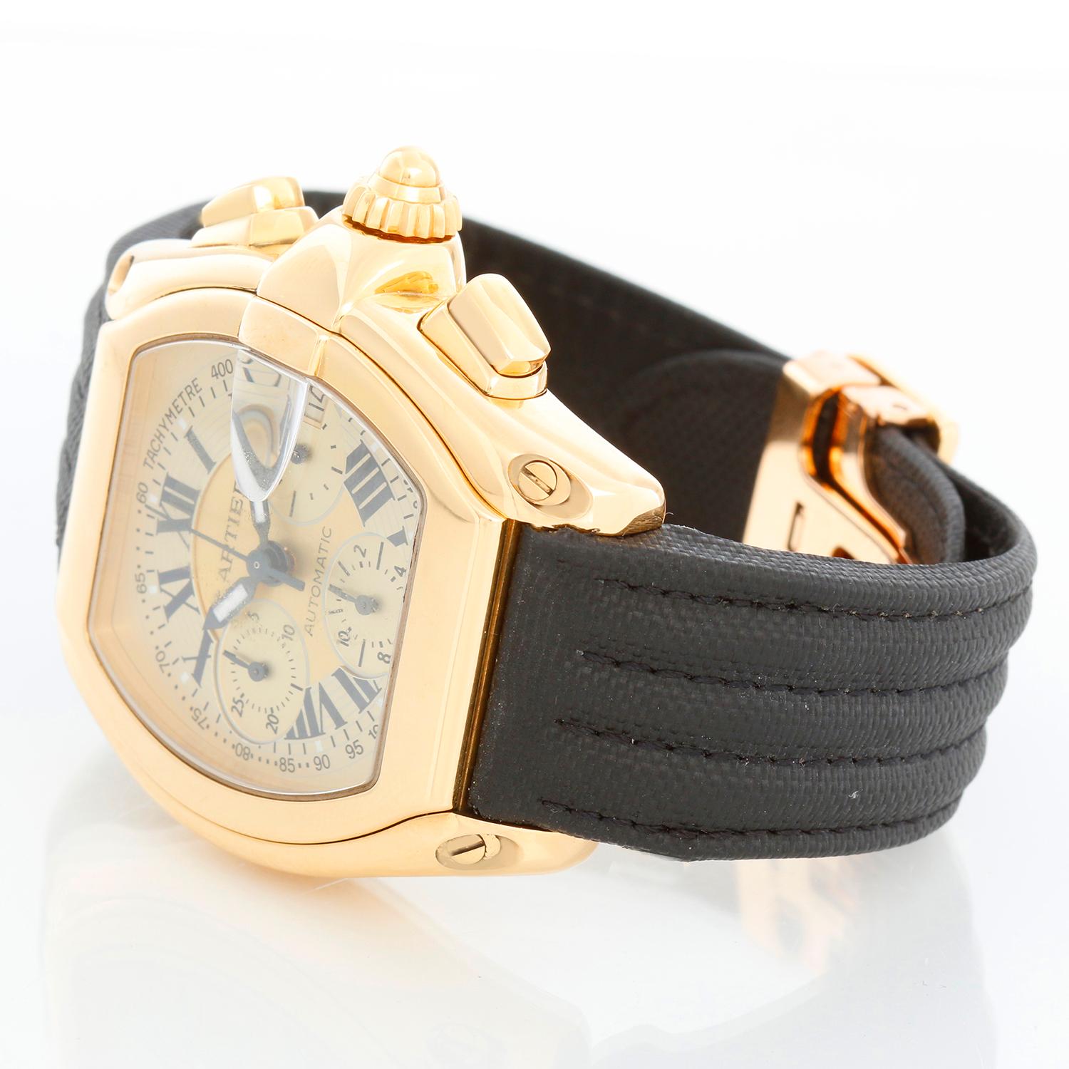 Cartier Roadster Chronograph 18k Yellow Gold Men's Watch 2619 - Automatic winding; chronograph with date. 18k yellow gold case (43 mm x 47mm). Champagne dial with Roman numerals . Black strap with 18K Yellow gold Cartier deployant clasp . Pre-owned