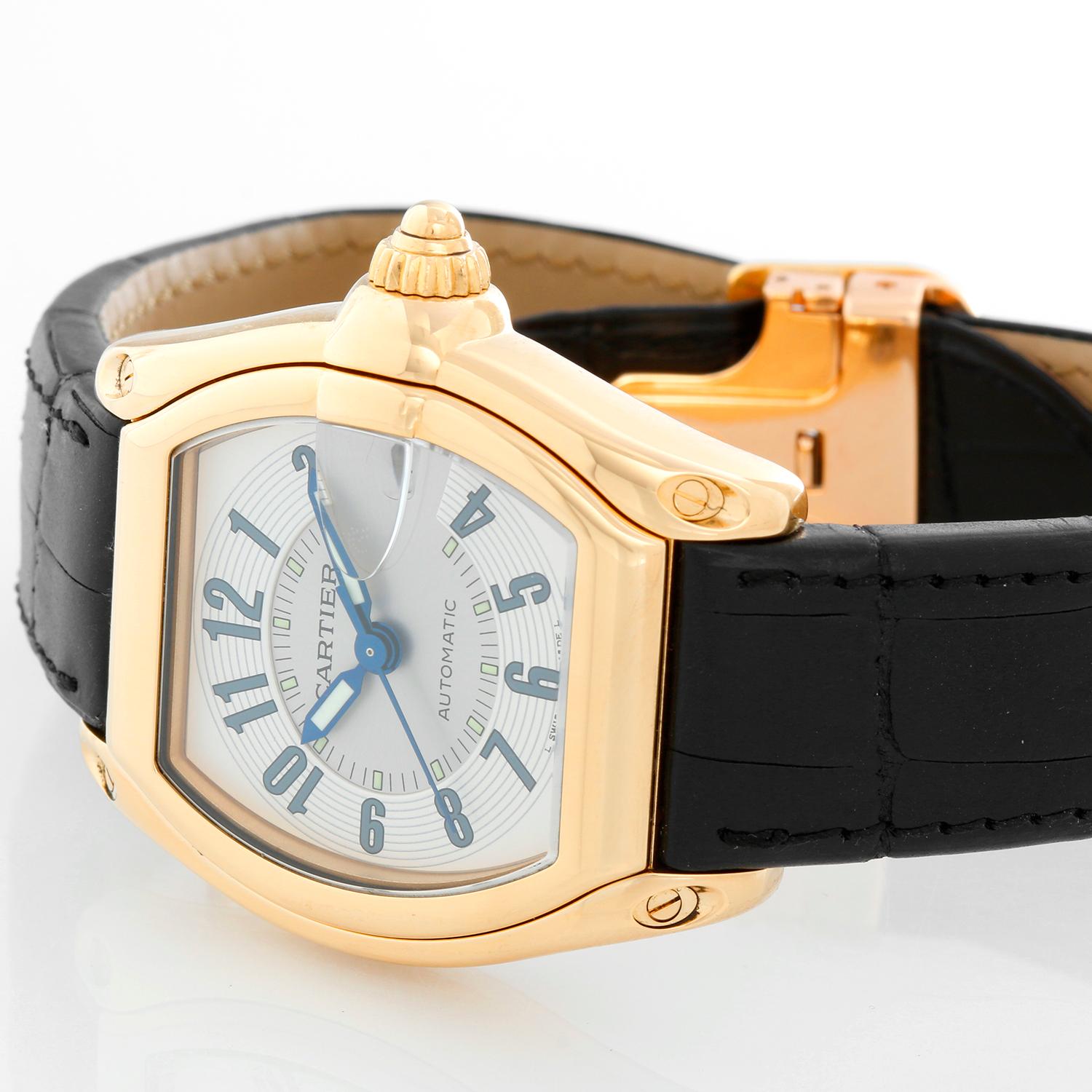 Cartier Roadster 18k Yellow Gold Men's Watch - Automatic winding with date at 3 o'clock . 18k yellow gold case (37mm x 44mm). Silver guilloche dial with black Arabic numerals. Black strap with 18K Yellow gold Cartier deployant clasp. Pre-owned with