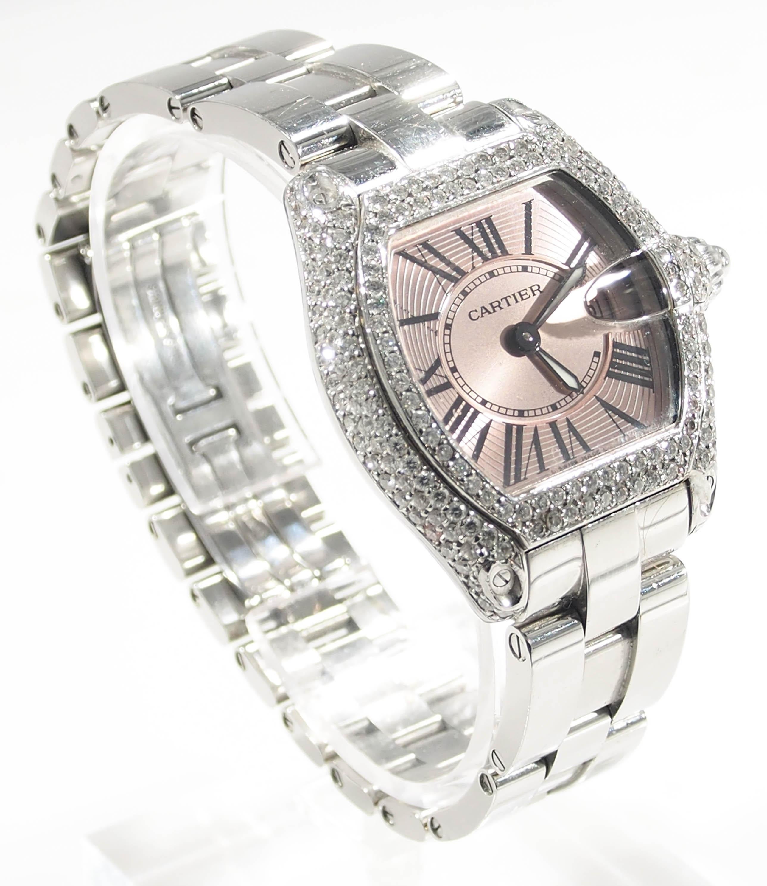 Desired by many is this Cartier Roadster Diamond Bezel Pink Face Roman Numeral Hour,Minute Stainless Steel Watch including the Box. This watch is a (Ladies) small and approximately 5 years old. The measurements are: Dial 21 millimeters by 22