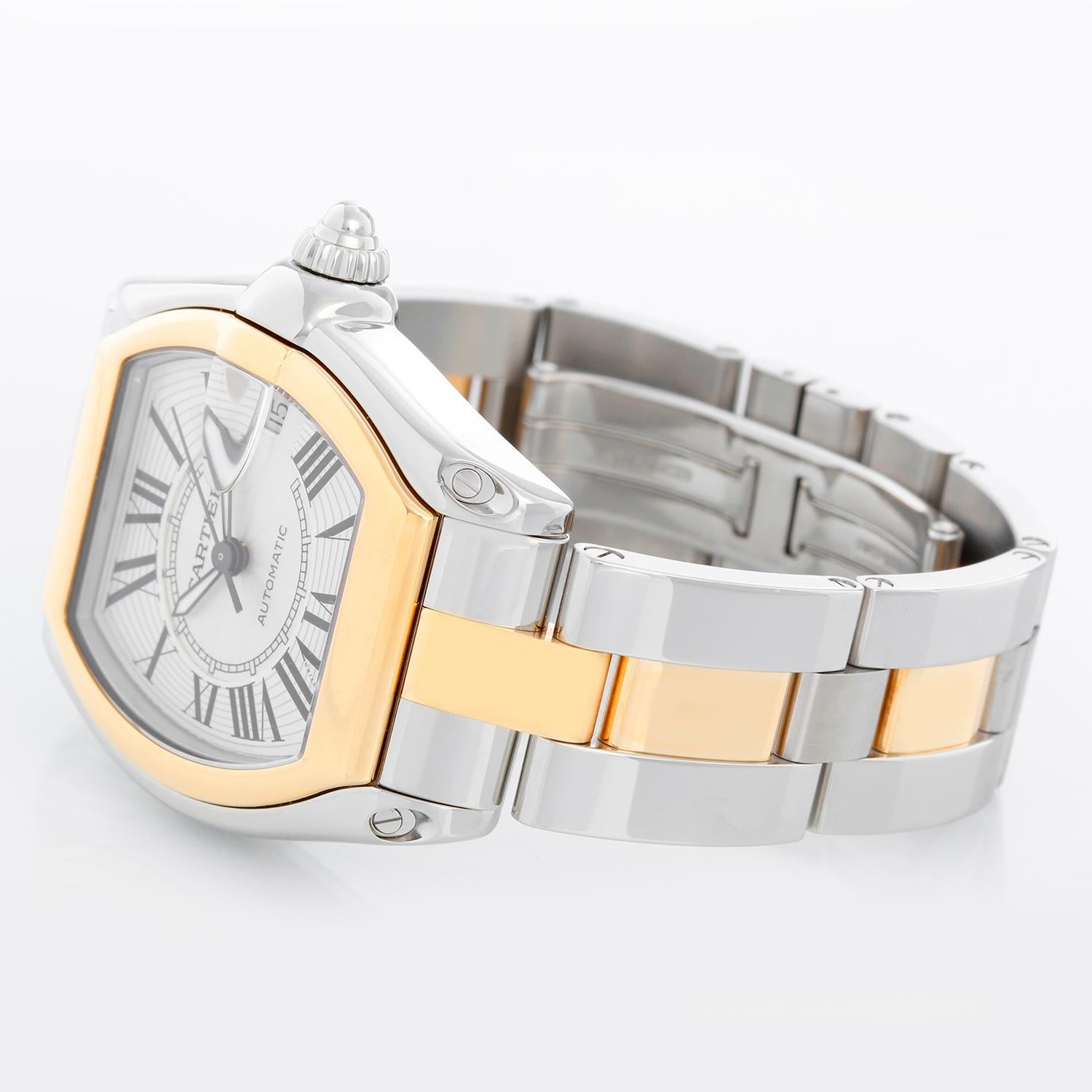 Cartier Roadster Men's Steel & Gold 2-Tone Watch W62031Y4 - Automatic winding. Stainless steel case with 18k yellow gold bezel. Silver dial with black Roman numerals; date at 3 o'clock. Stainless steel and 18k yellow gold Cartier Roadster bracelet