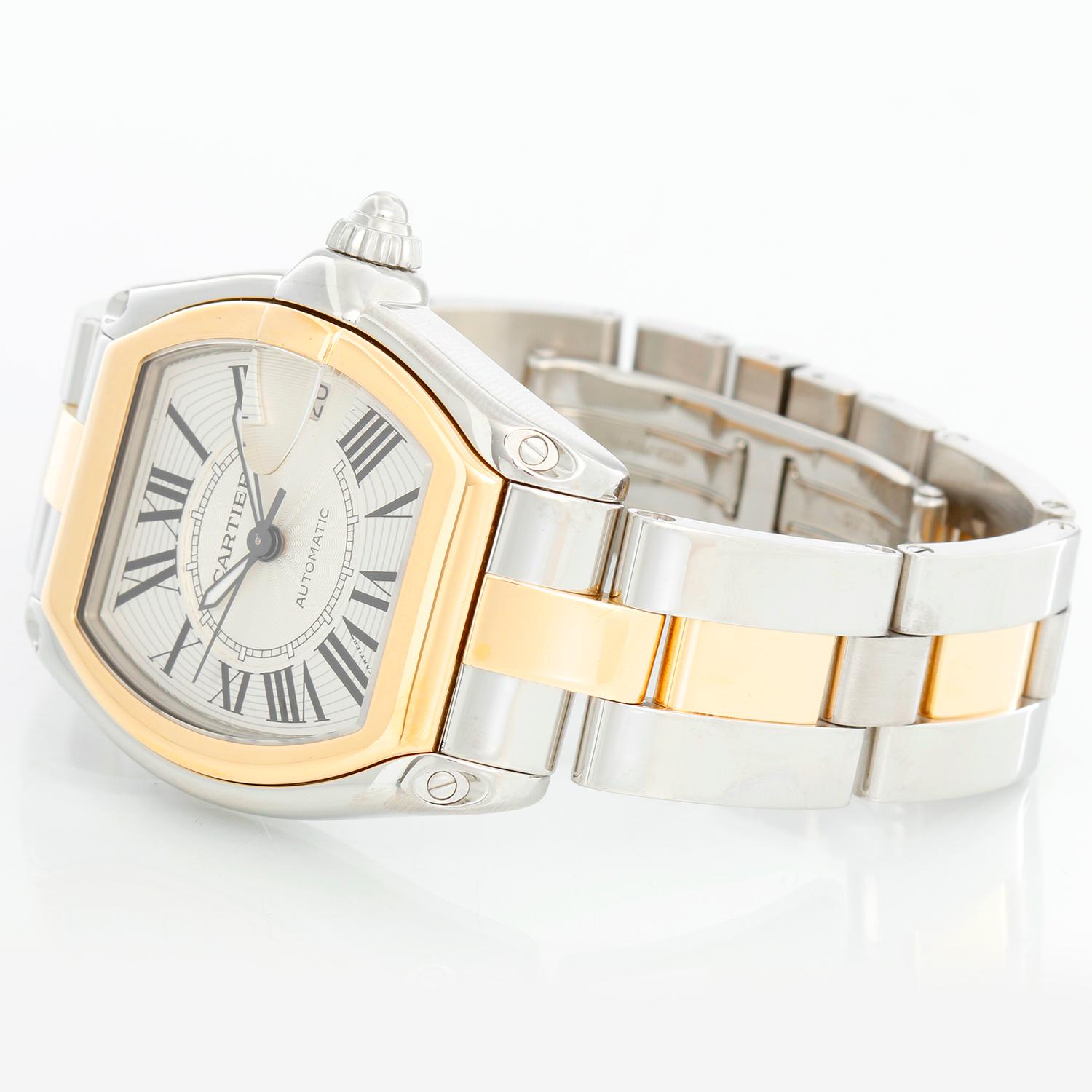 Cartier Roadster Men's Steel & Gold 2-Tone Watch W62031Y4 - Automatic winding. Stainless steel case with 18k yellow gold bezel. Silver dial with black Roman numerals; date at 3 o'clock. Stainless steel and 18k yellow gold Cartier Roadster bracelet