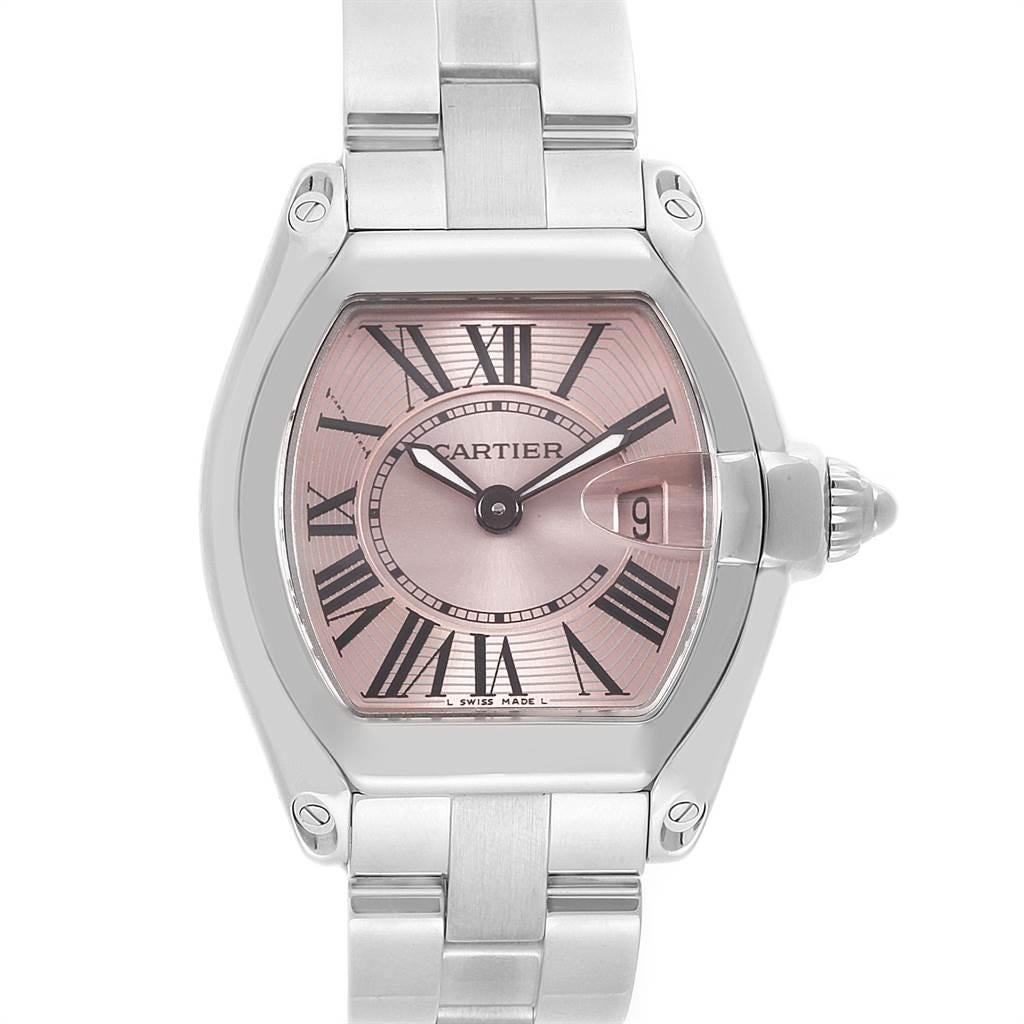 Cartier Roadster Pink Dial Stainless Steel Ladies Watch W62017V3. Swiss quartz movement calibre 688. Stainless steel tonneau shaped case 36 x 30 mm. Scratch resistant sapphire crystal with cyclops magnifying glass. Pink sunray effect dial with black