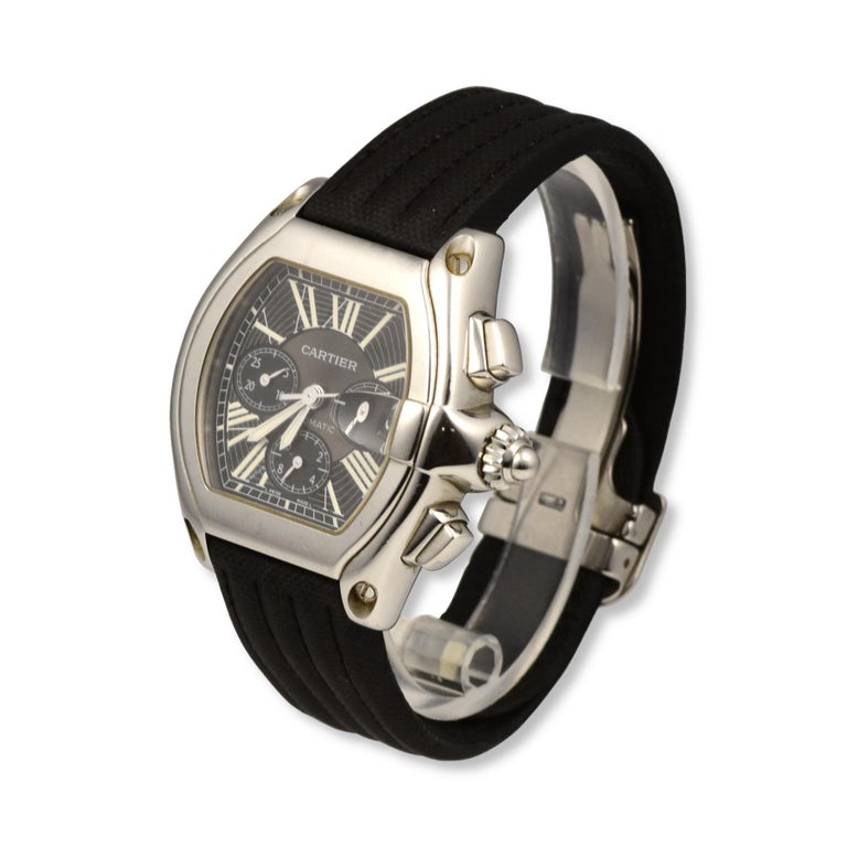 Brand: Cartier
Model: Roadster 
Movement: Automatic 
Case Size: 48 x 43 mm
Dial: Roman Numeral
Case Material: Stainless Steel 
Bracelet Material: Textile
Crystal: Scratch-Resistant Sapphire Glass
Includes: 24 Month Brilliance Jewels Warrant
        