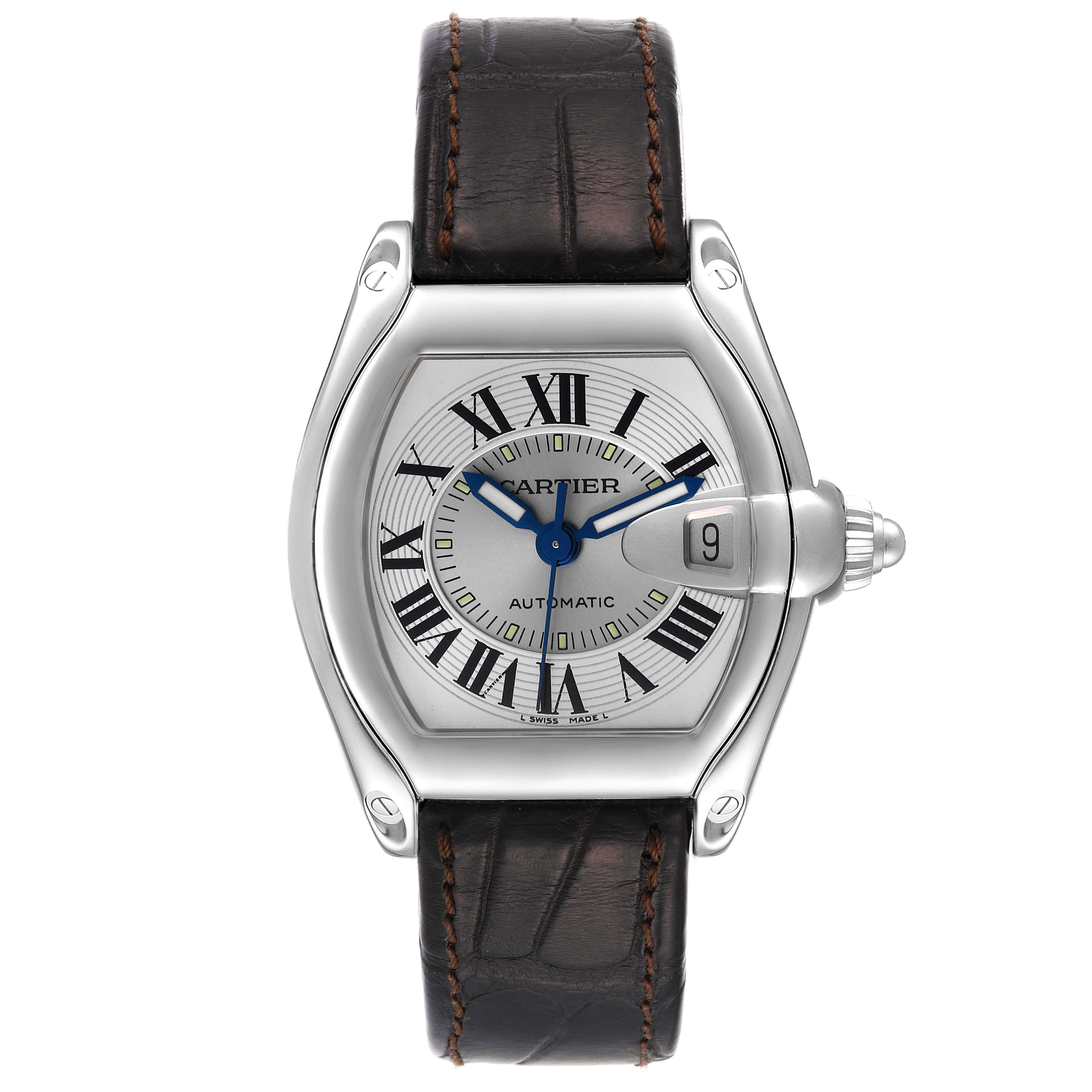 Cartier Roadster Silver Dial Brown Strap Steel Mens Watch W62000V3. Automatic self-winding movement. Stainless steel tonneau shaped case 38 x 43mm. . Scratch resistant sapphire crystal with cyclops magnifying glass. Silver sunray dial with black