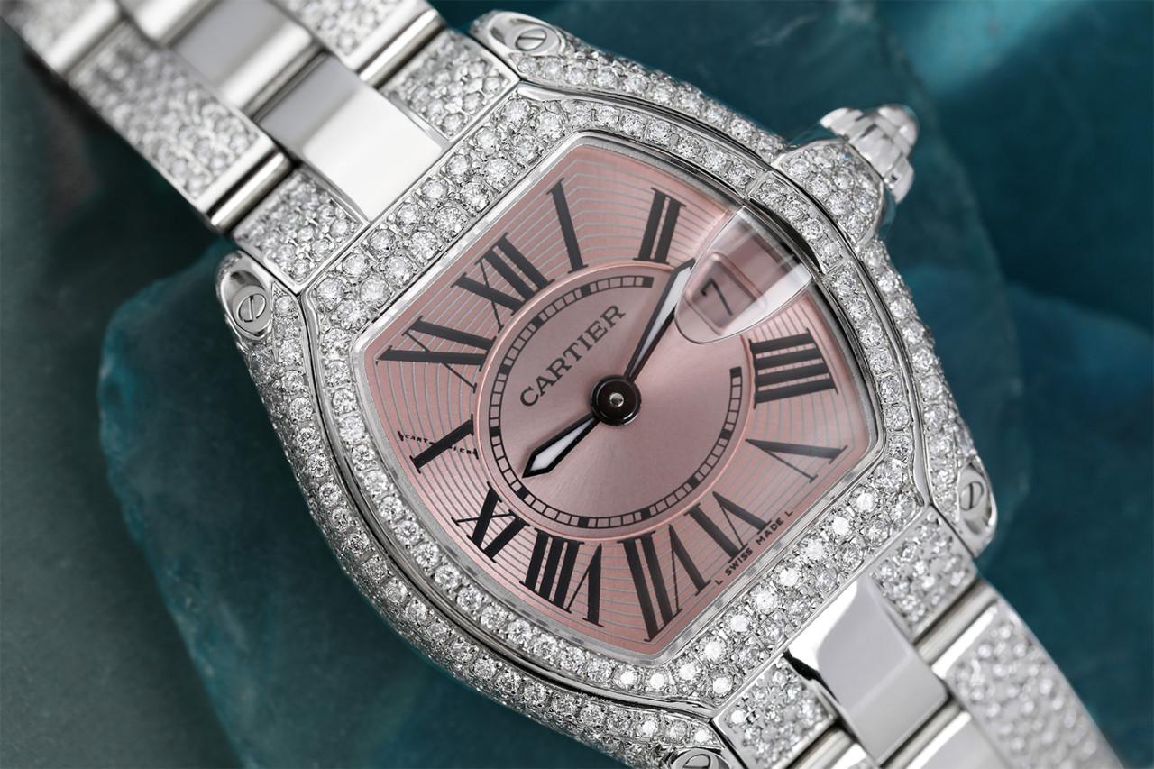 Cartier Roadster Stainless Steel Ladies Watch Diamond Case and Side Bracelet W62016V3 

 Pink-tone dial with luminous hands and black Roman numeral hour markers. Minute markers around an inner ring. Dial Type: Analog. Luminescent hands and dial