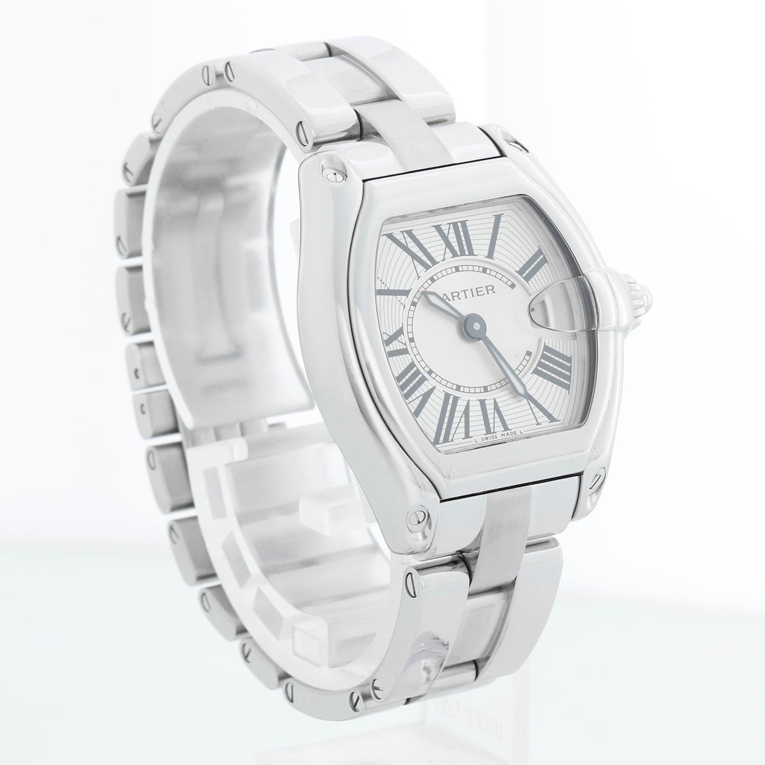 Cartier Roadster Stainless Steel Ladies Watch W62016V3 - Quartz. Ladies Roadster. Stainless steel tonneau style case. Siilver guilloche dial with black Roman numerals; date at 3 o'clock. Stainless steel Cartier bracelet with deployant clasp; will