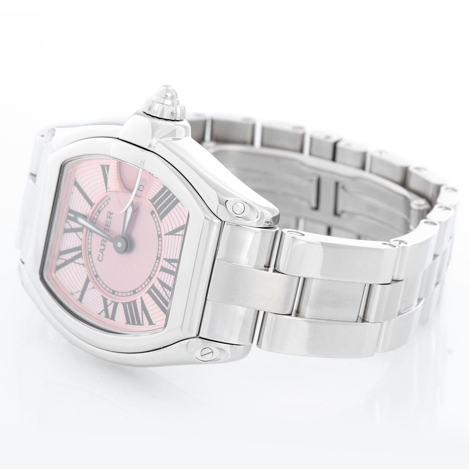 Cartier Roadster Stainless Steel Ladies Watch W62016V3 - Quartz. Stainless steel tonneau style case ( 30 x 36 mm ) . Pink guilloche dial with black Roman numerals; date at 3 o'clock. Stainless steel Cartier bracelet with deployant clasp. Pre-owned